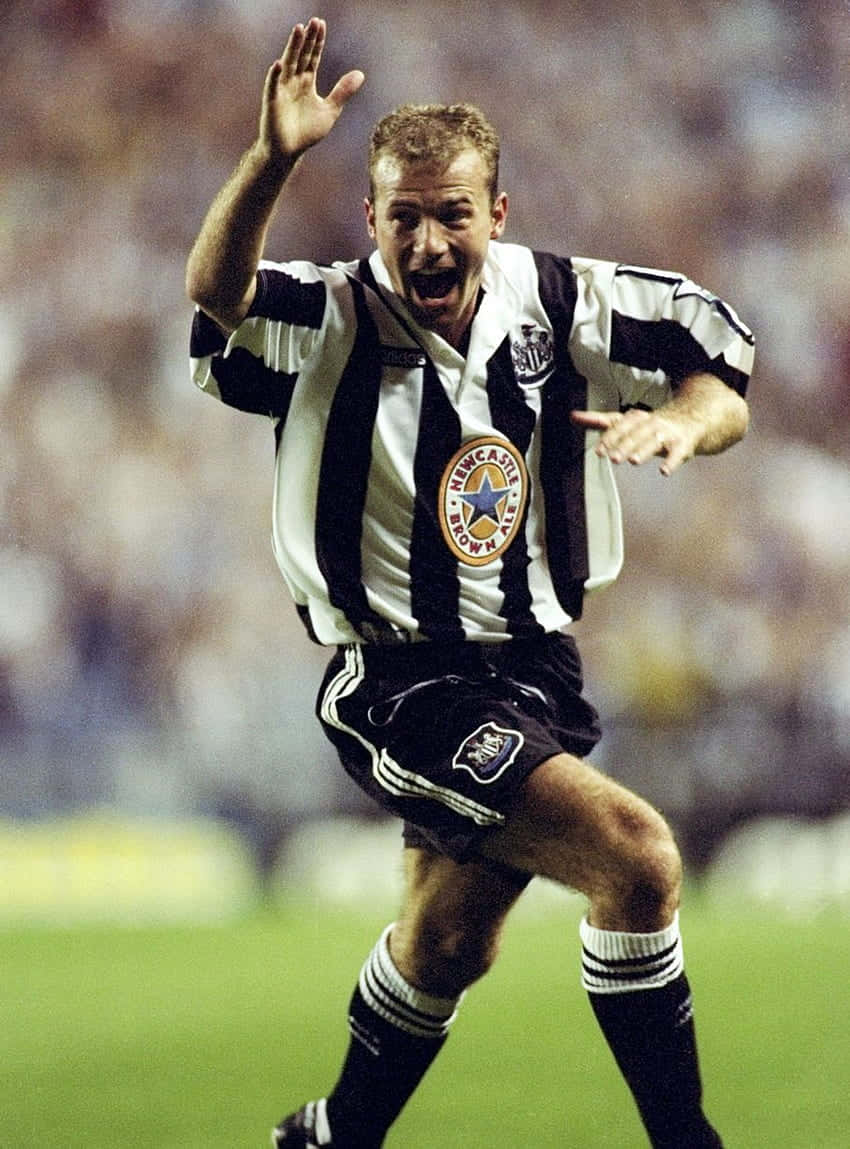 Alan Shearer Celebrating In Newcastle United Fc Kit Background