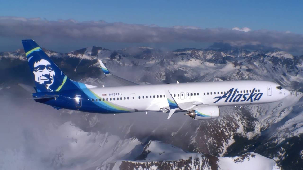 Alaska Airlines Flying Above Snow Mountains