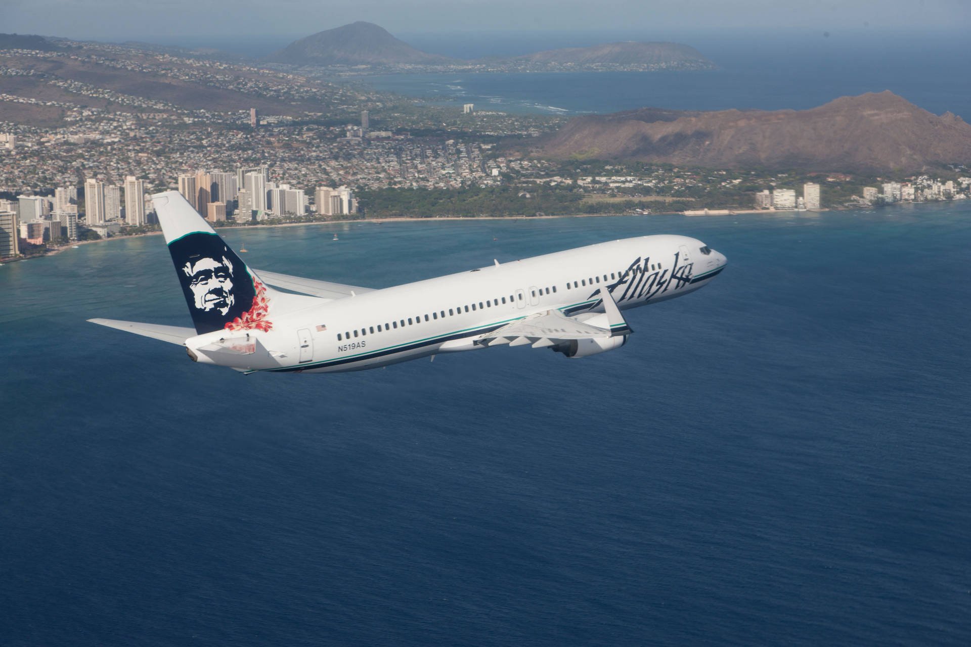 Alaska Airlines Flying Above The Ocean Background