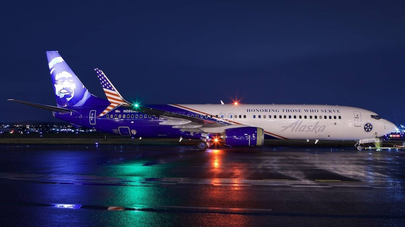 Alaska Airlines' Illuminated Aircraft - A Splash Of Color In The Sky Background