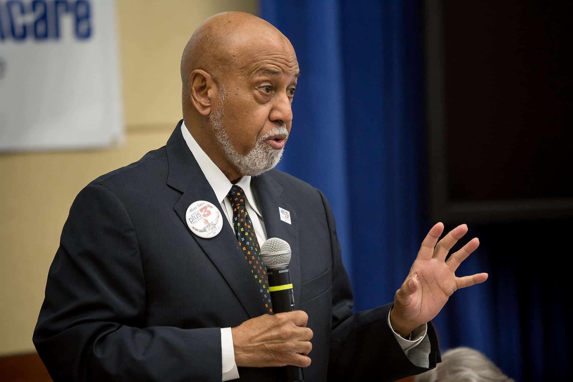 Alcee Hastings Passionately Delivering A Speech To An Engaged Audience. Background