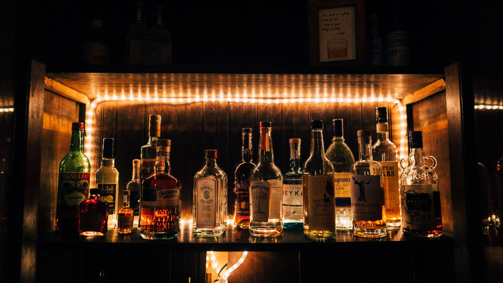 Alcohol Bottles On Shelf With Light