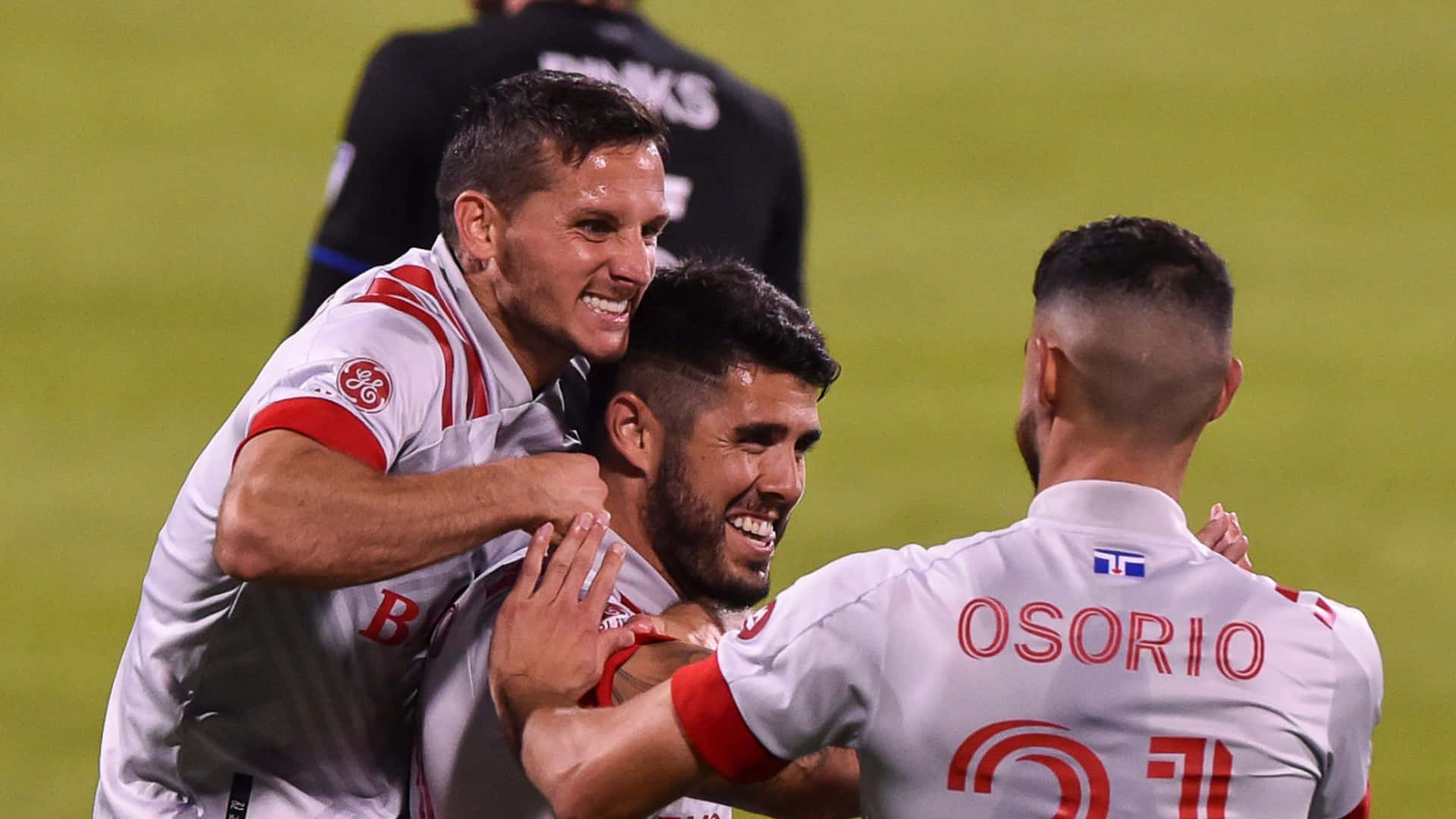 Alejandro Pozuelo And Jonathan Osorio Of Toronto Fc Celebrating On The Field Background