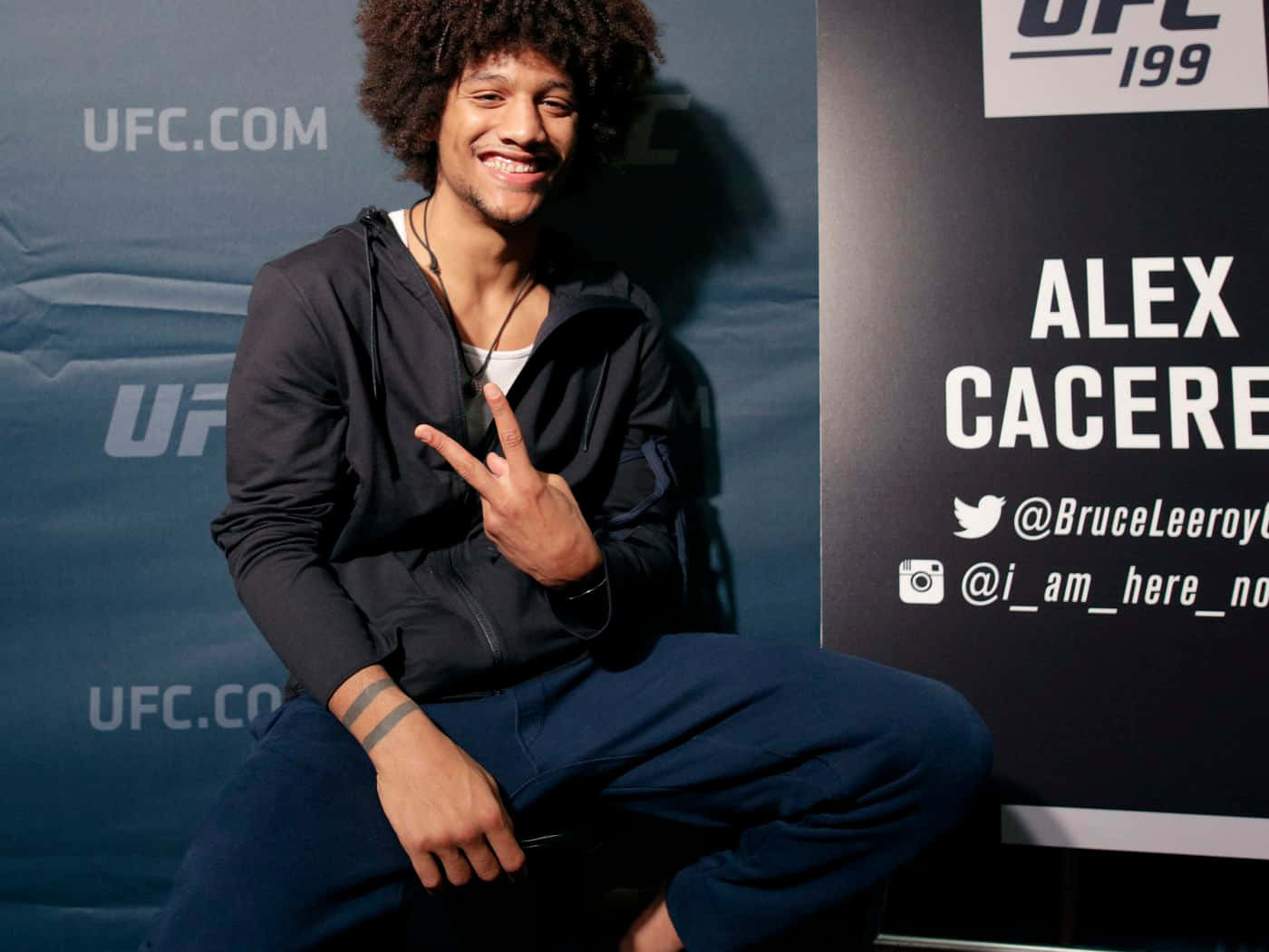Alex Caceres Posing Peace Sign Background