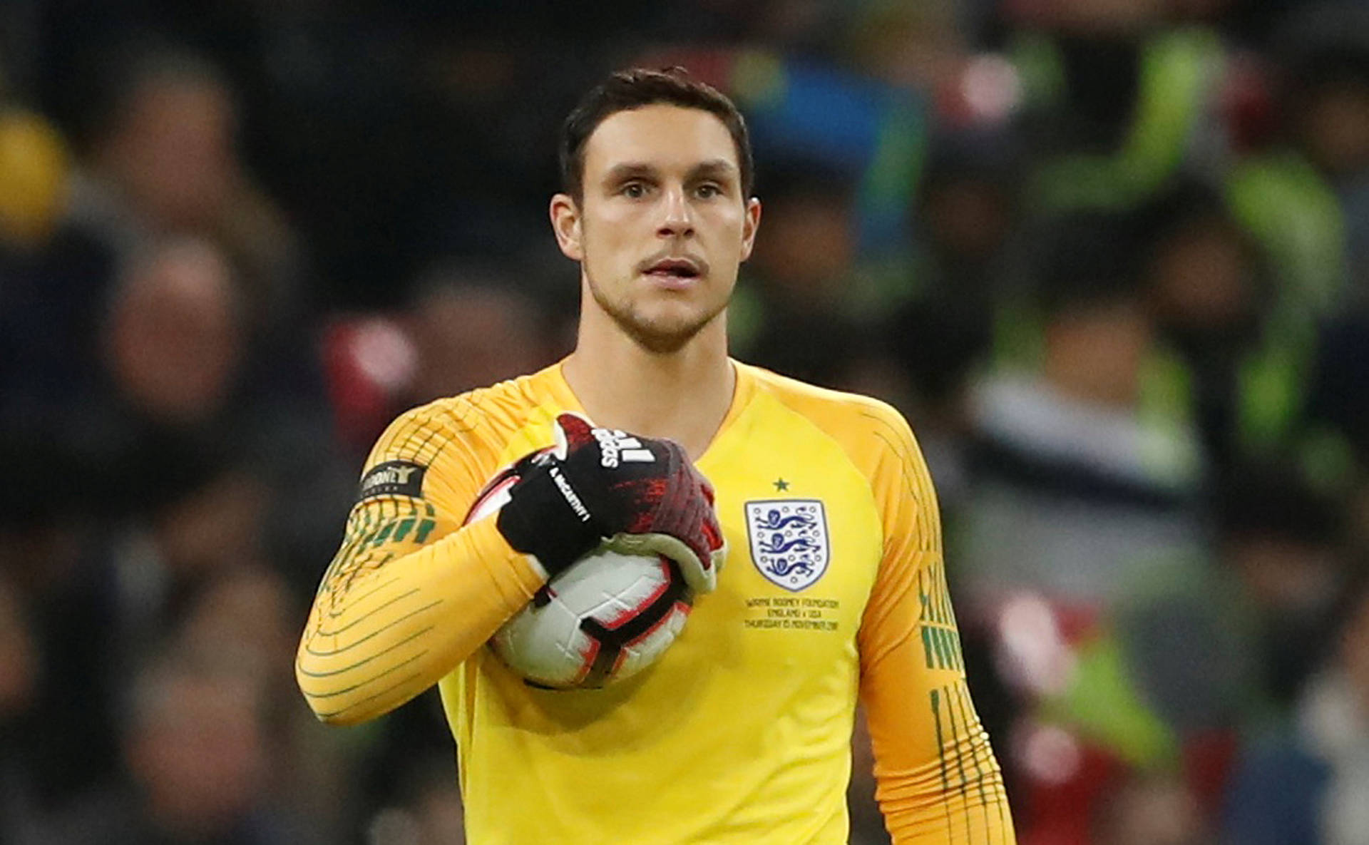 Alex Mccarthy Holding A Soccer Ball Background