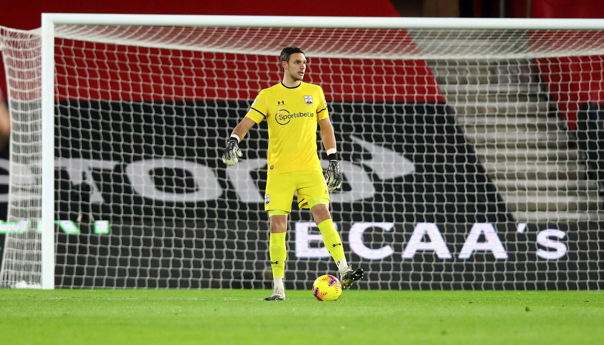 Alex Mccarthy In A Yellow Jersey Background