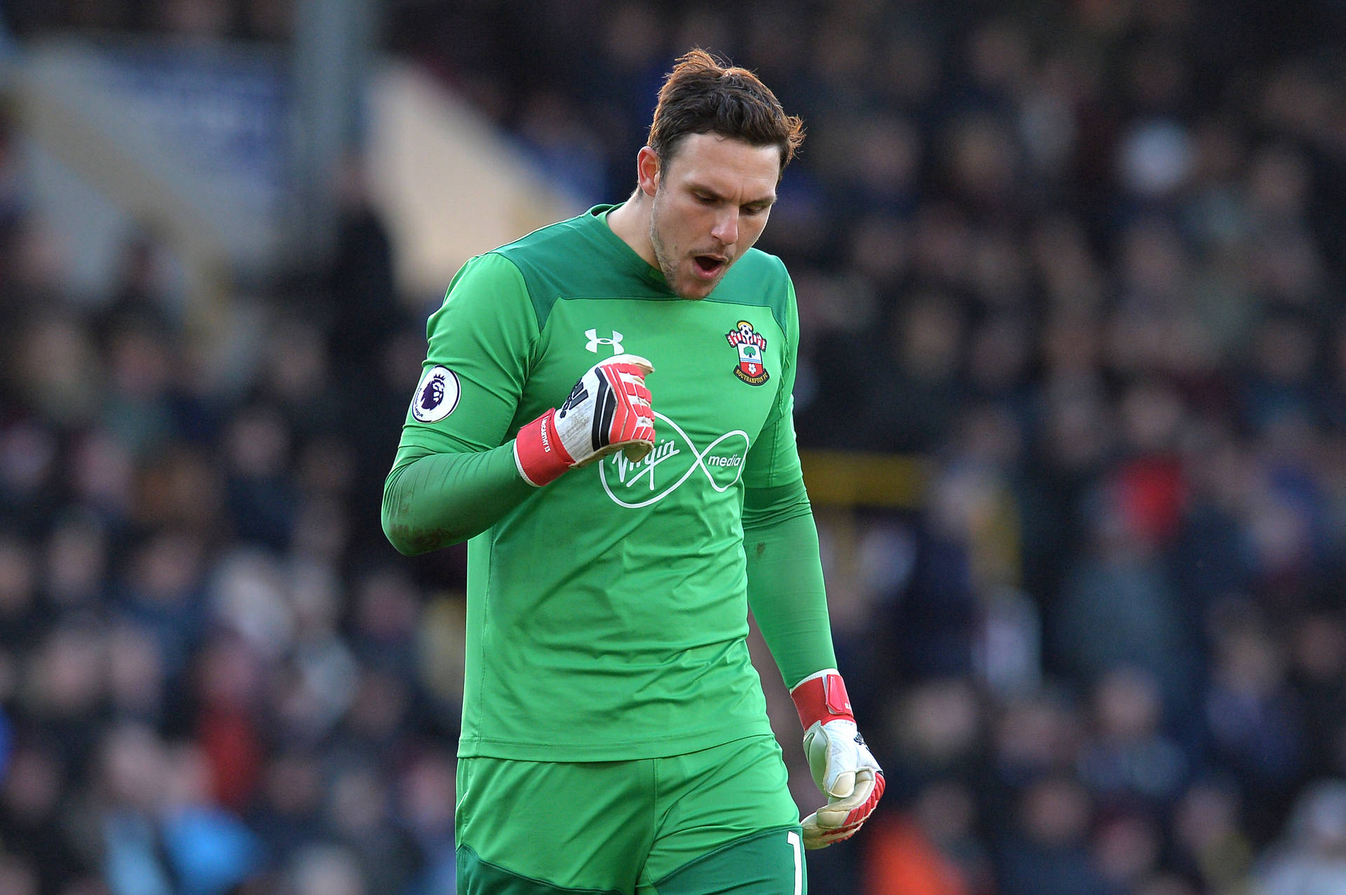 Alex Mccarthy In Action With A Green Jersey Background