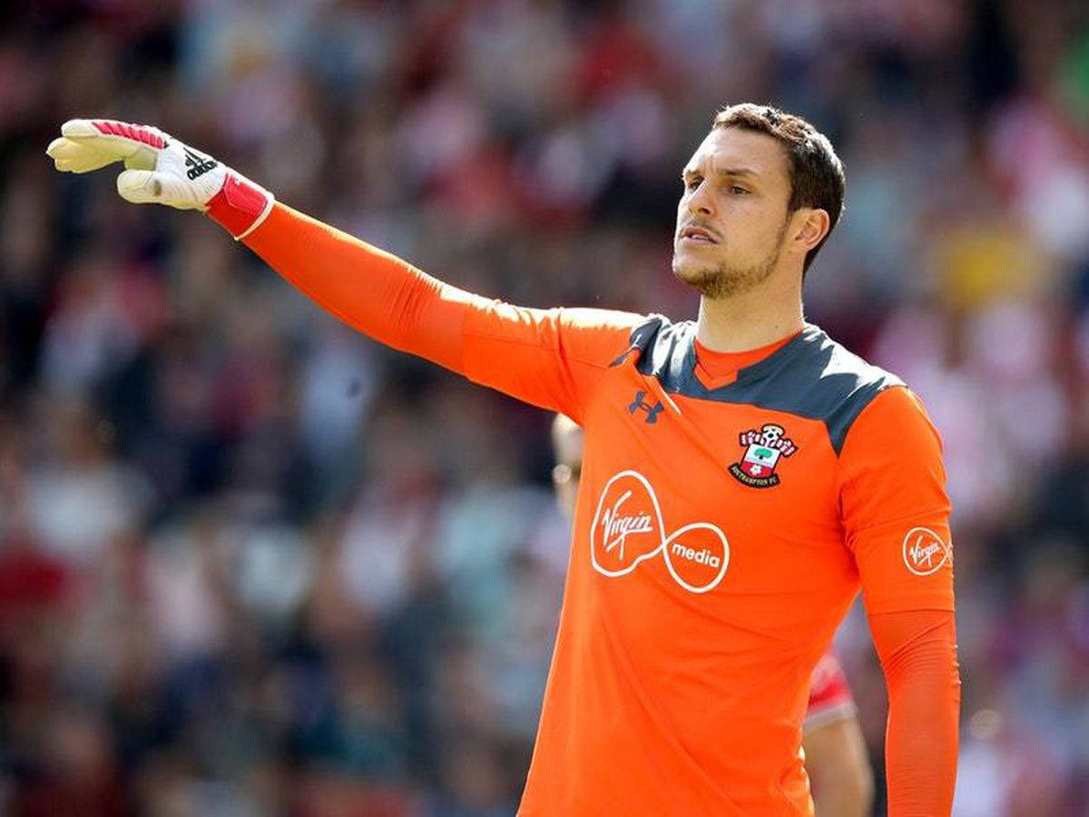 Alex Mccarthy In Bright Orange Jersey Background