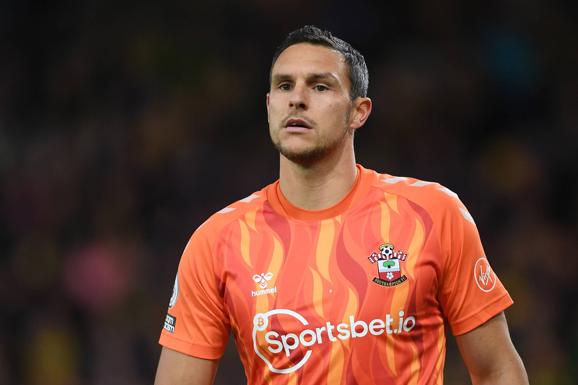 Alex Mccarthy In Orange Jersey Background