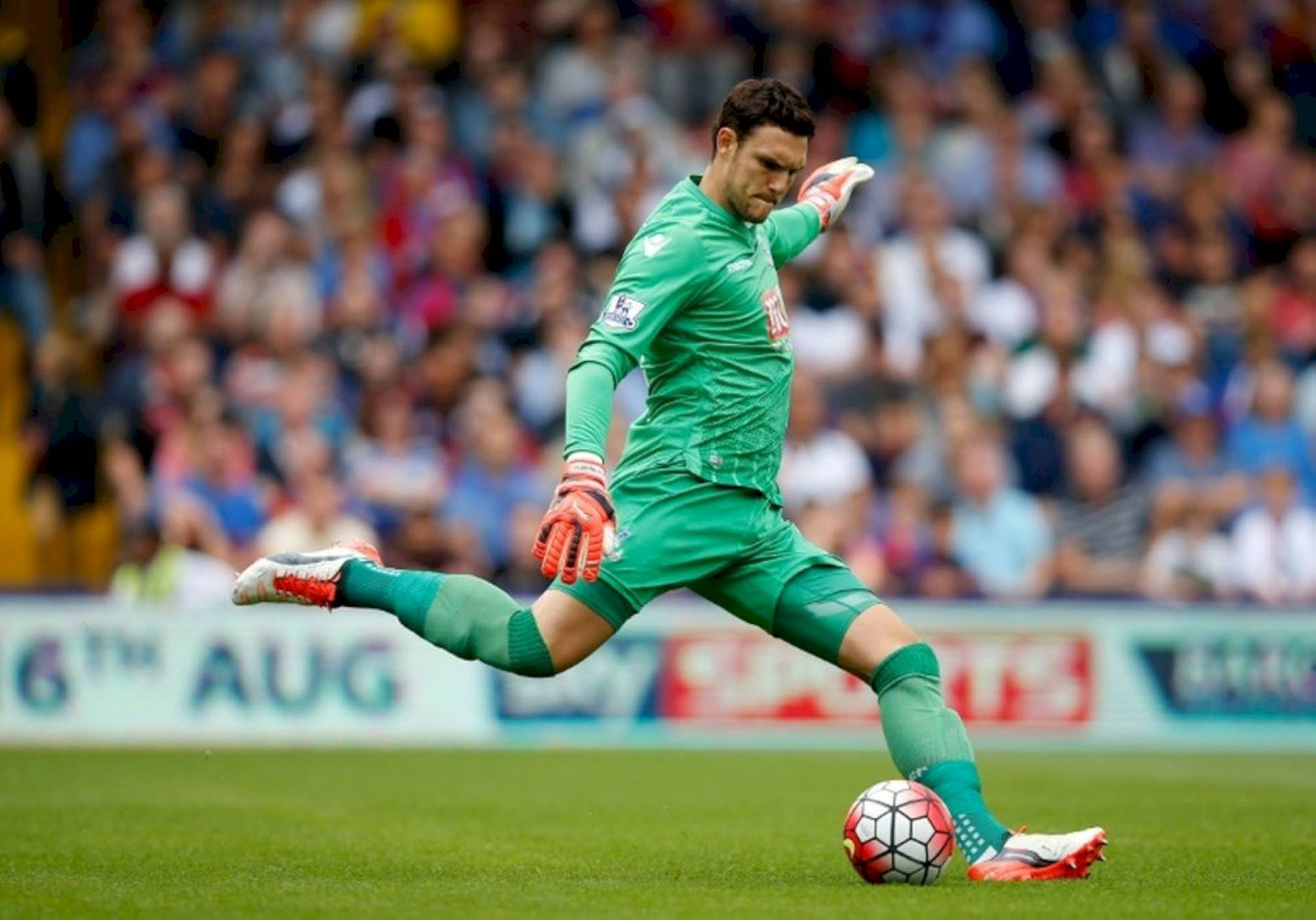 Alex Mccarthy Kicking A Soccer Ball Background