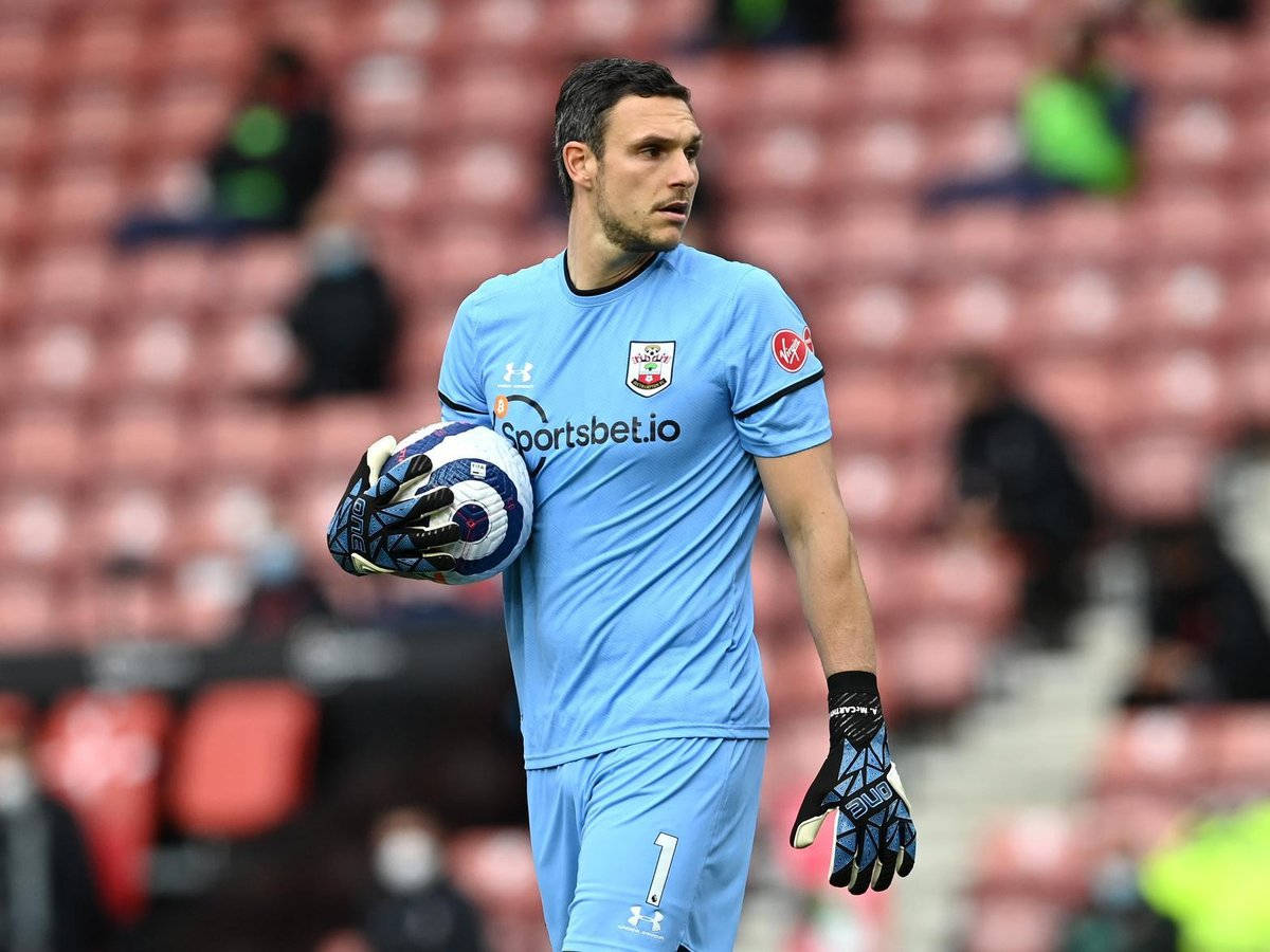 Alex Mccarthy Walking While Holding A Ball