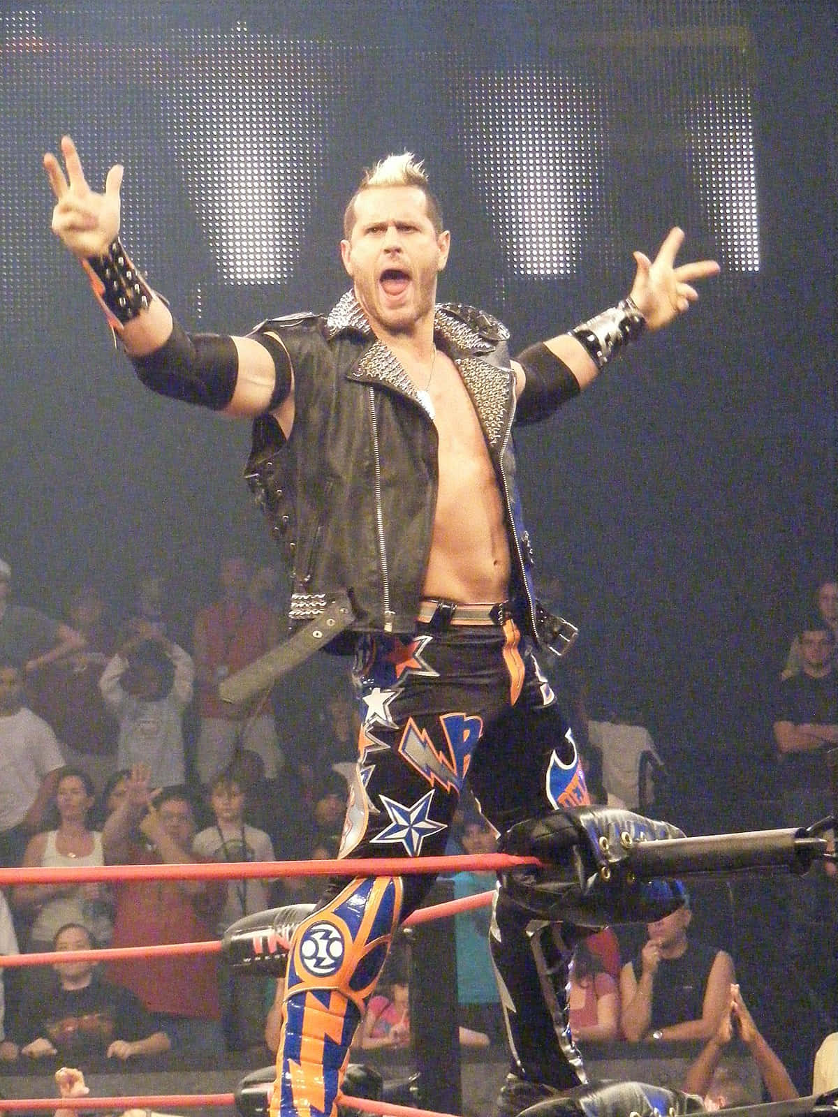 Alex Shelley Posing On Top Of Ring During Entrance Background