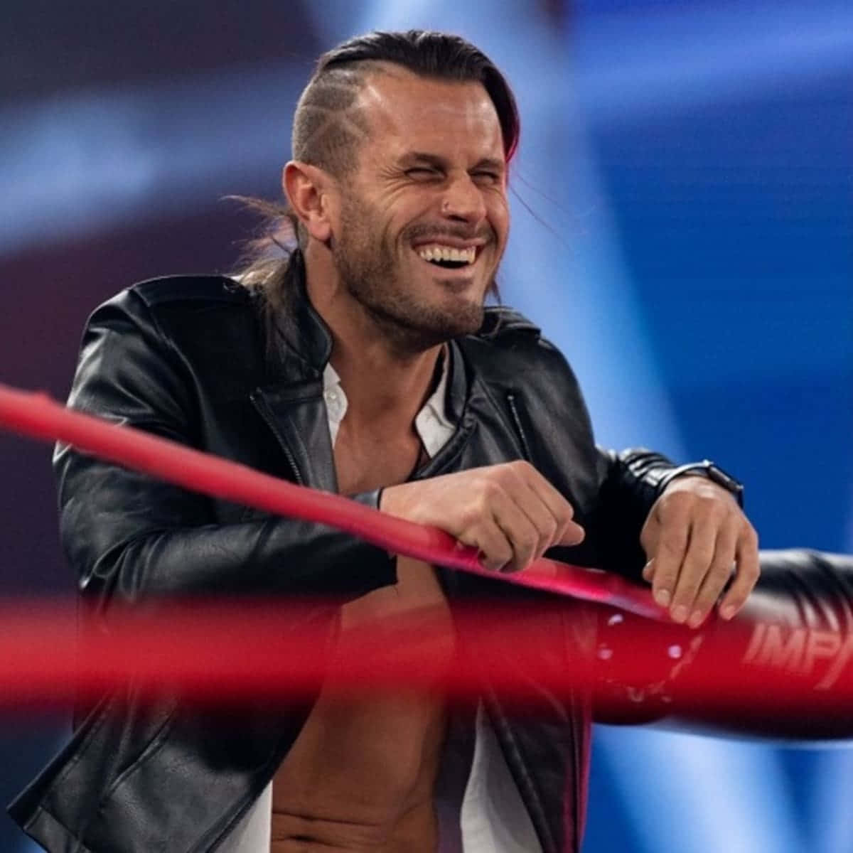 Alex Shelley Smiling On Impact Wrestling Background