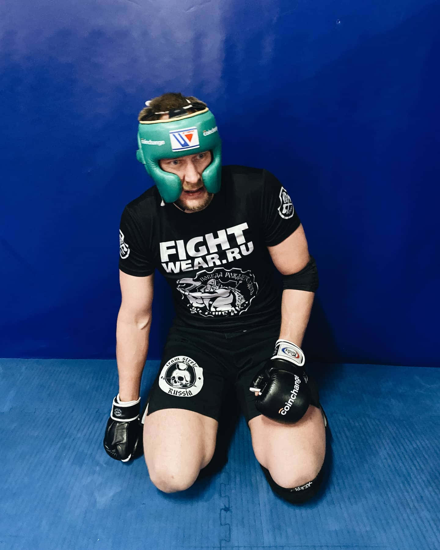 Alexander Volkov Kneeling Blue Background