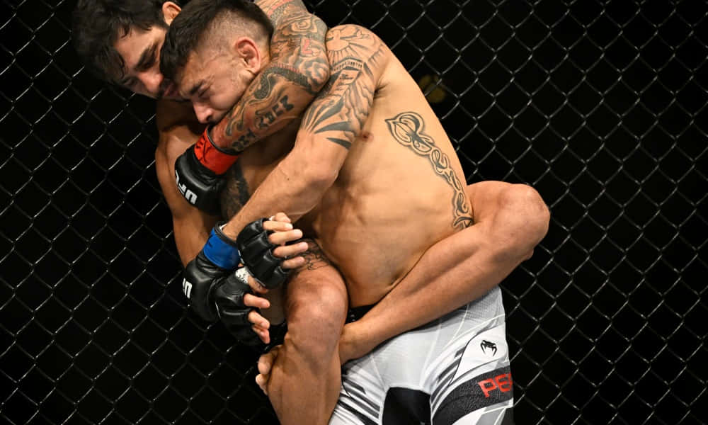 Alexandre Pantoja Arm Around Opponents Head Background