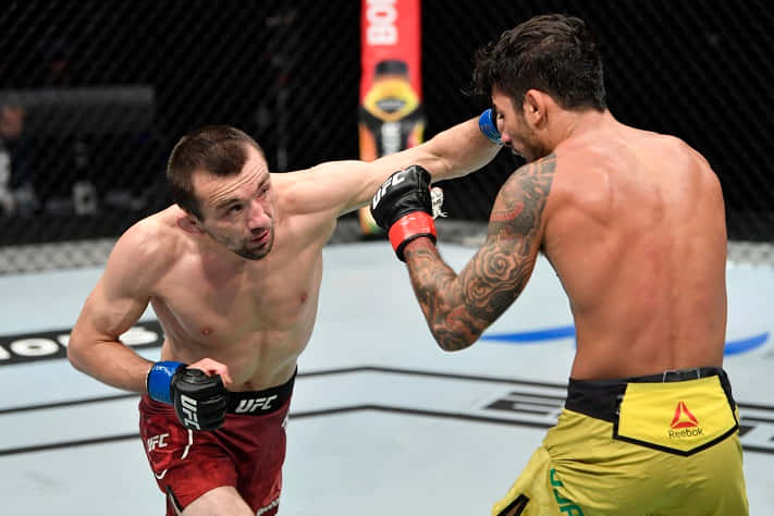 Alexandre Pantoja Getting Punched By Askar Askarov Background