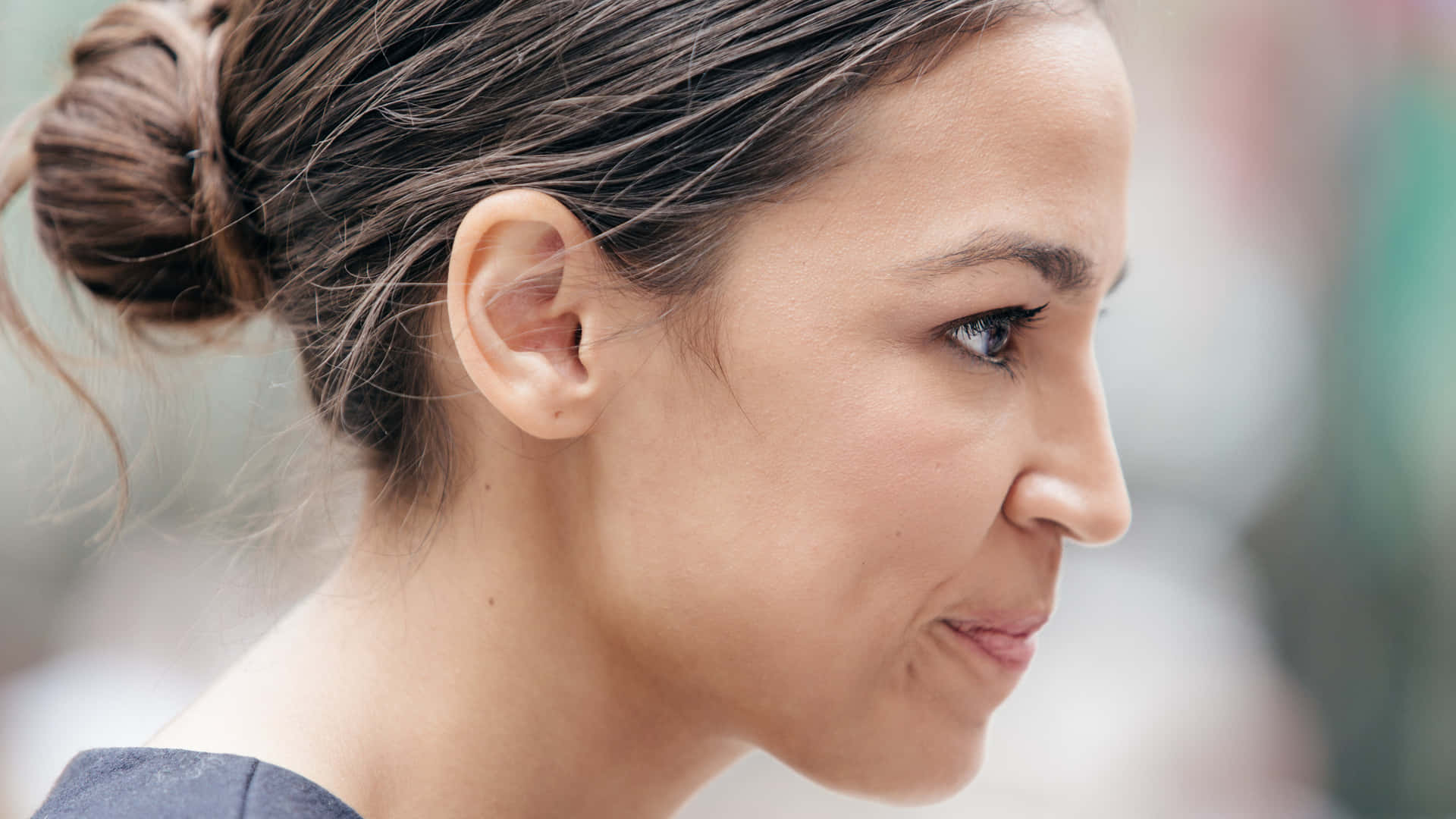 Alexandria Ocasio-cortez In A Thoughtful Look Background
