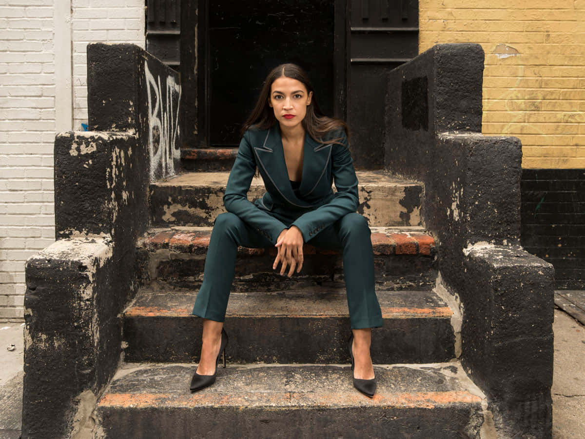 Alexandria Ocasio-cortez Sitting On The Steps Background