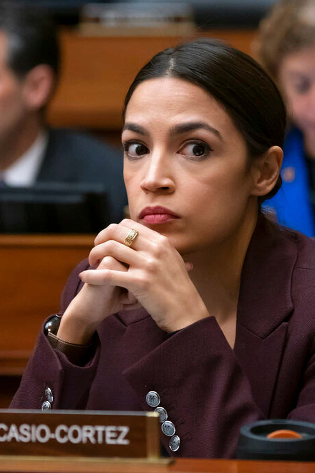 Alexandria Ocasio-cortez With Hands Intertwined Background