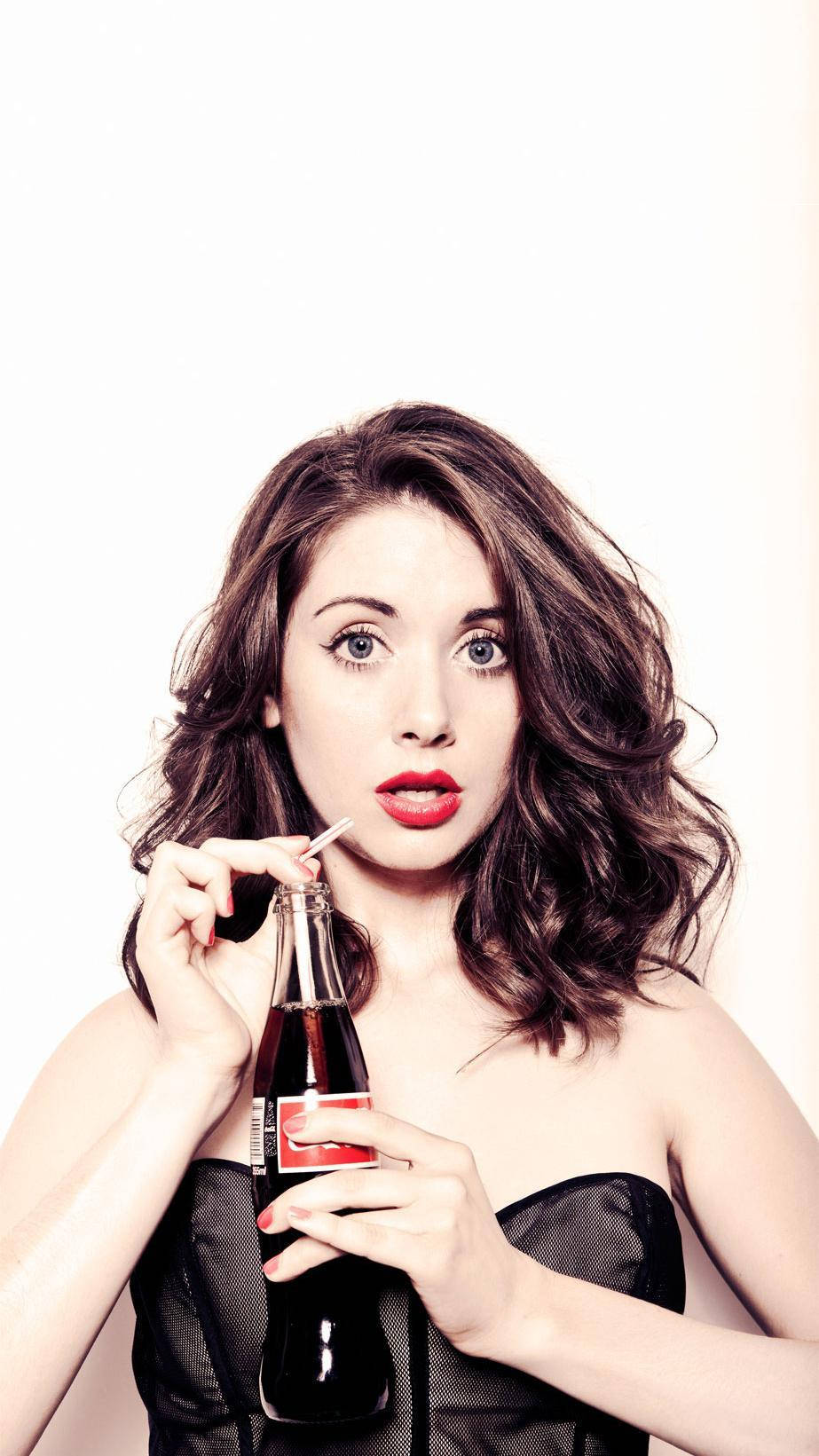 Alison Brie And Her Coke Bottle Background