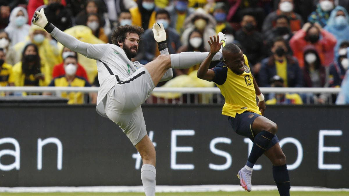 Alisson Becker Colliding With Enner Valencia Background