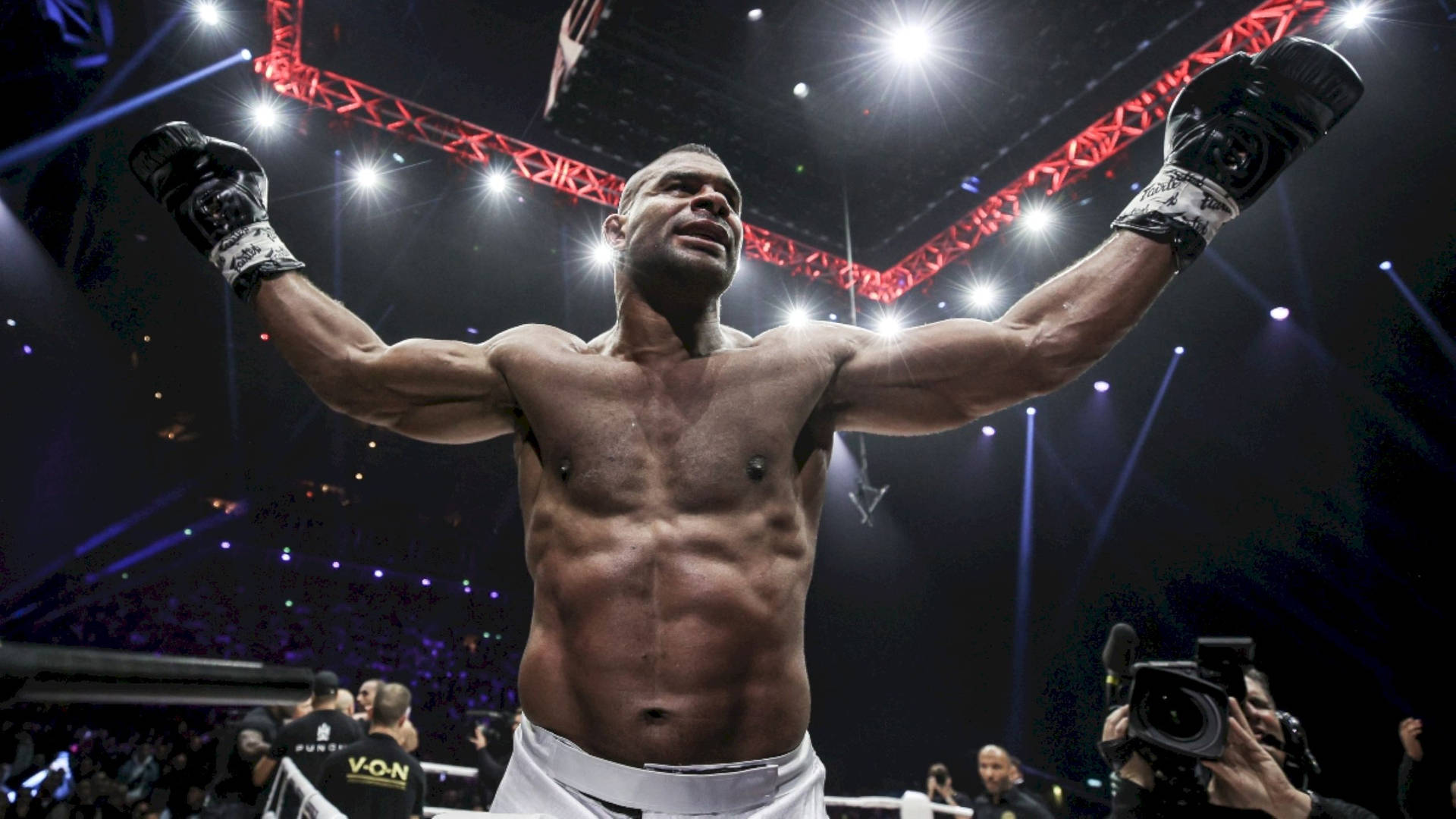 Alistair Overeem Wearing Black Gloves Background