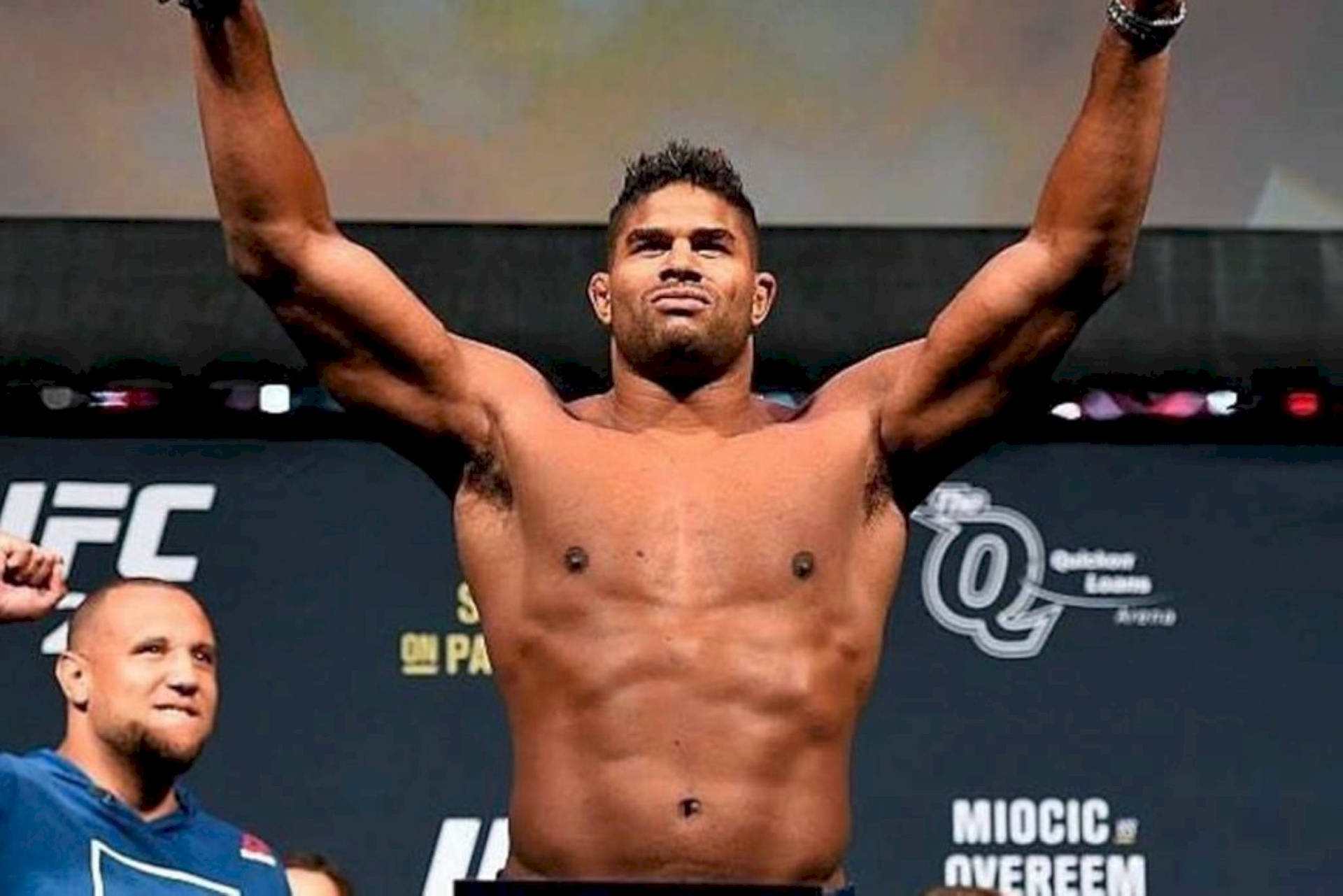 Alistair Overeem With Arms Up Background