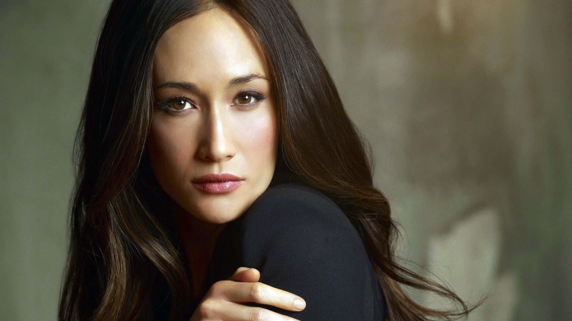 Alluring Maggie Q Posing Elegantly Background