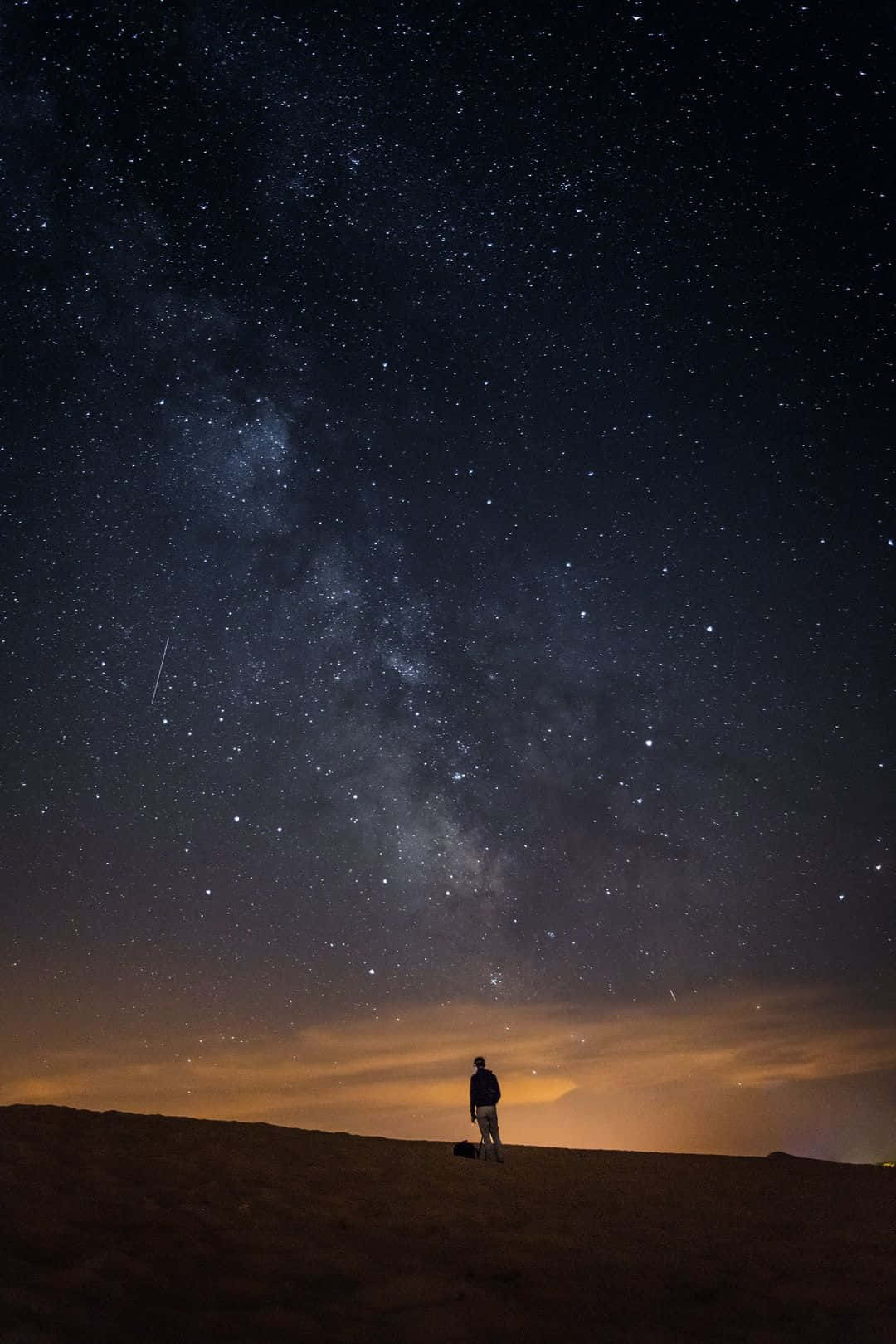 Alone Man In A Dark Starry Night Background