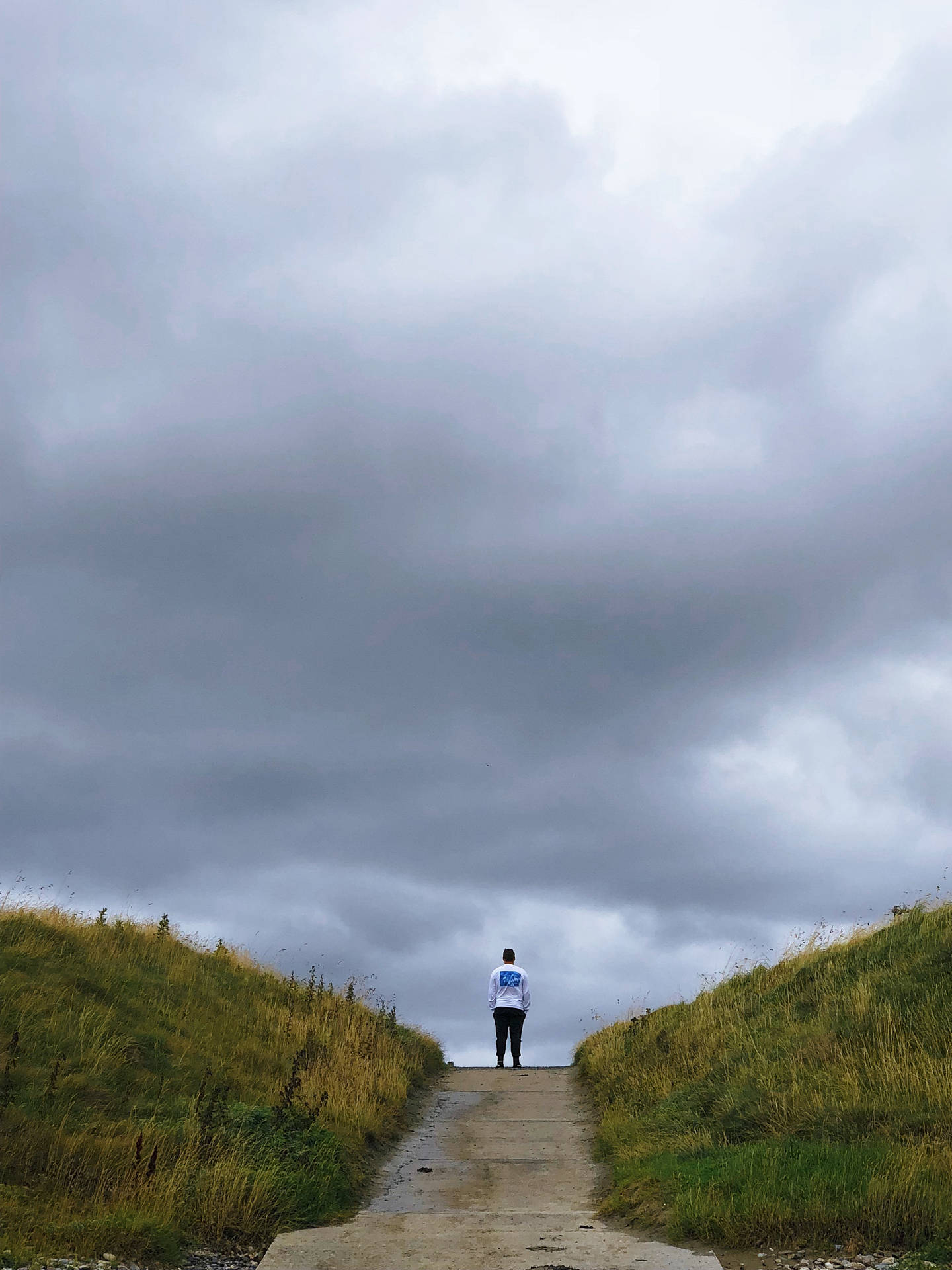 Alone Man Over Storm Clouds Background