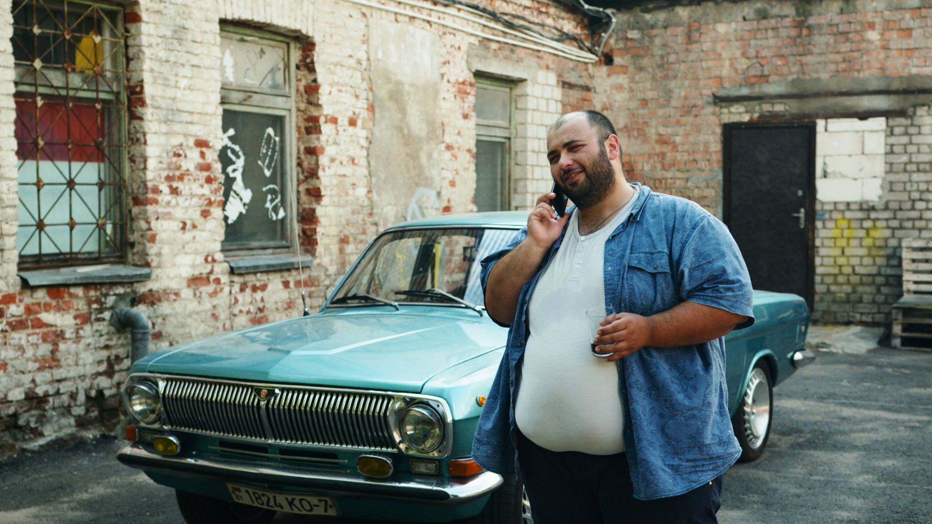 Aloof, Plus-sized Individual Casually Talking Over The Phone