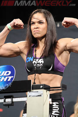 Amanda Nunes Flex On Stage Background