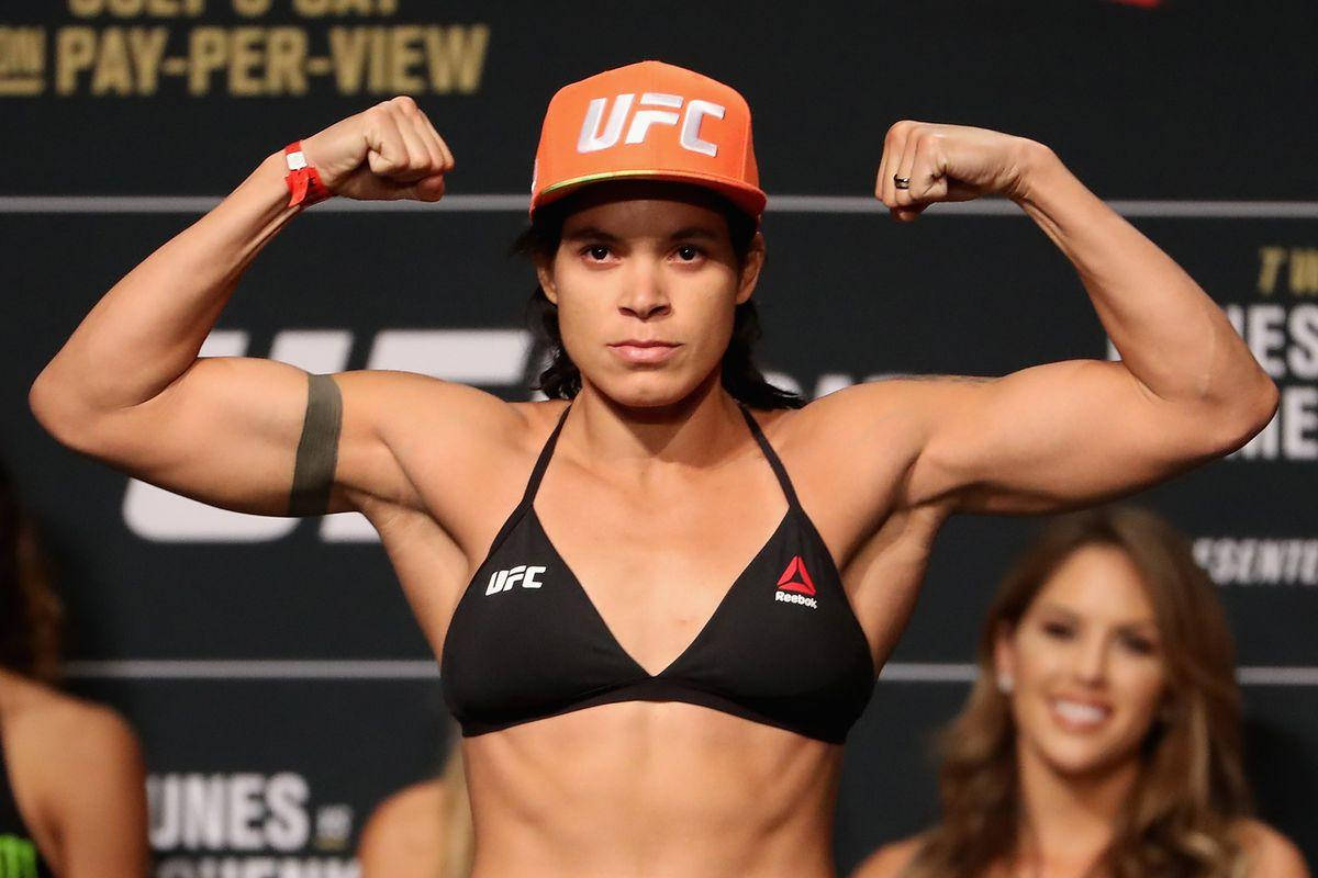 Amanda Nunes Flexing Muscles Background