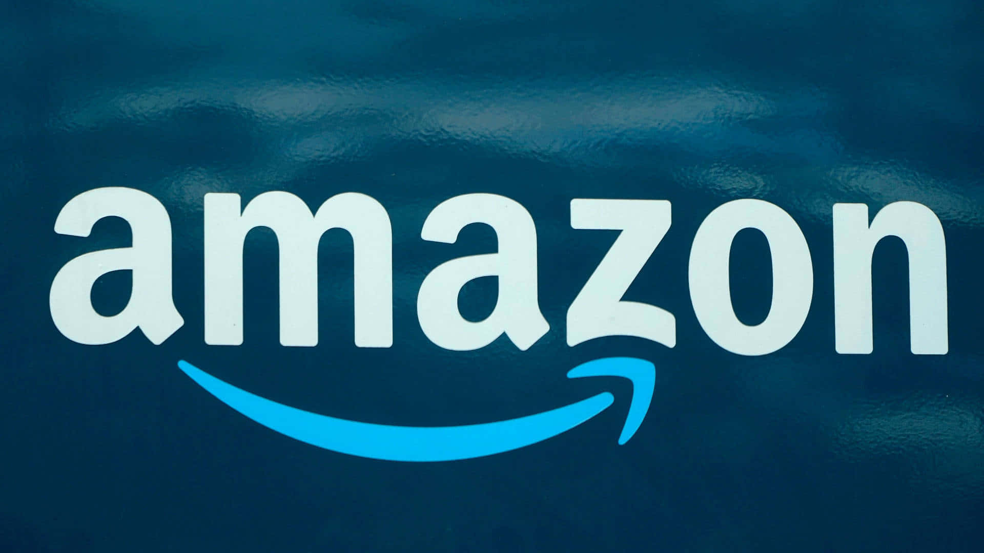 Amazon Uk's Iconic Logo Featuring A Blue Arrow
