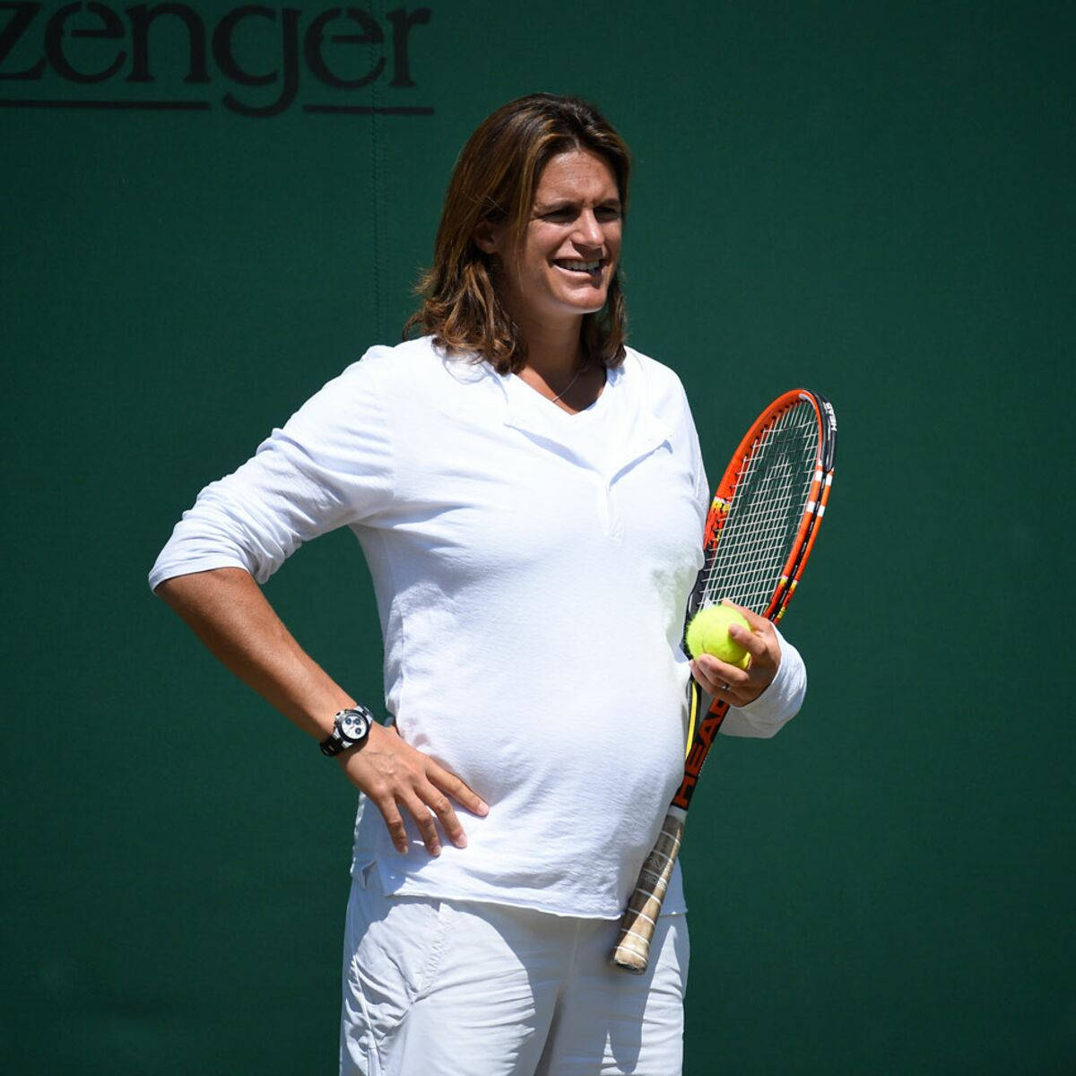 Amélie Mauresmo Observing On The Sidelines During A Tennis Match.