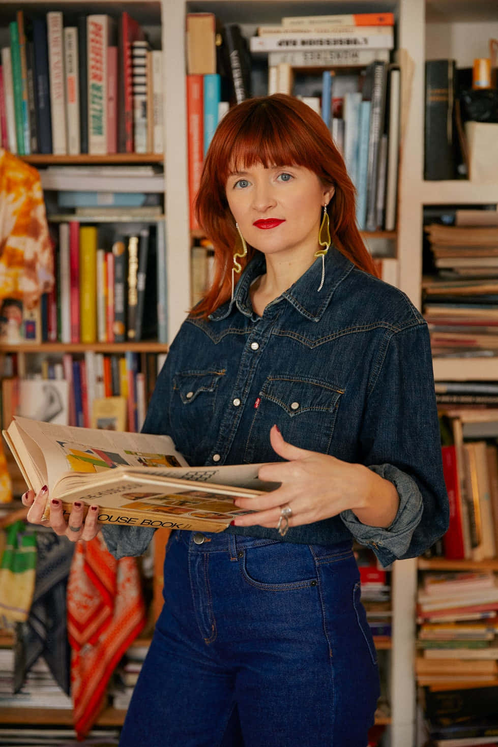 Amélie Pichard Against A Wall Of Books Background