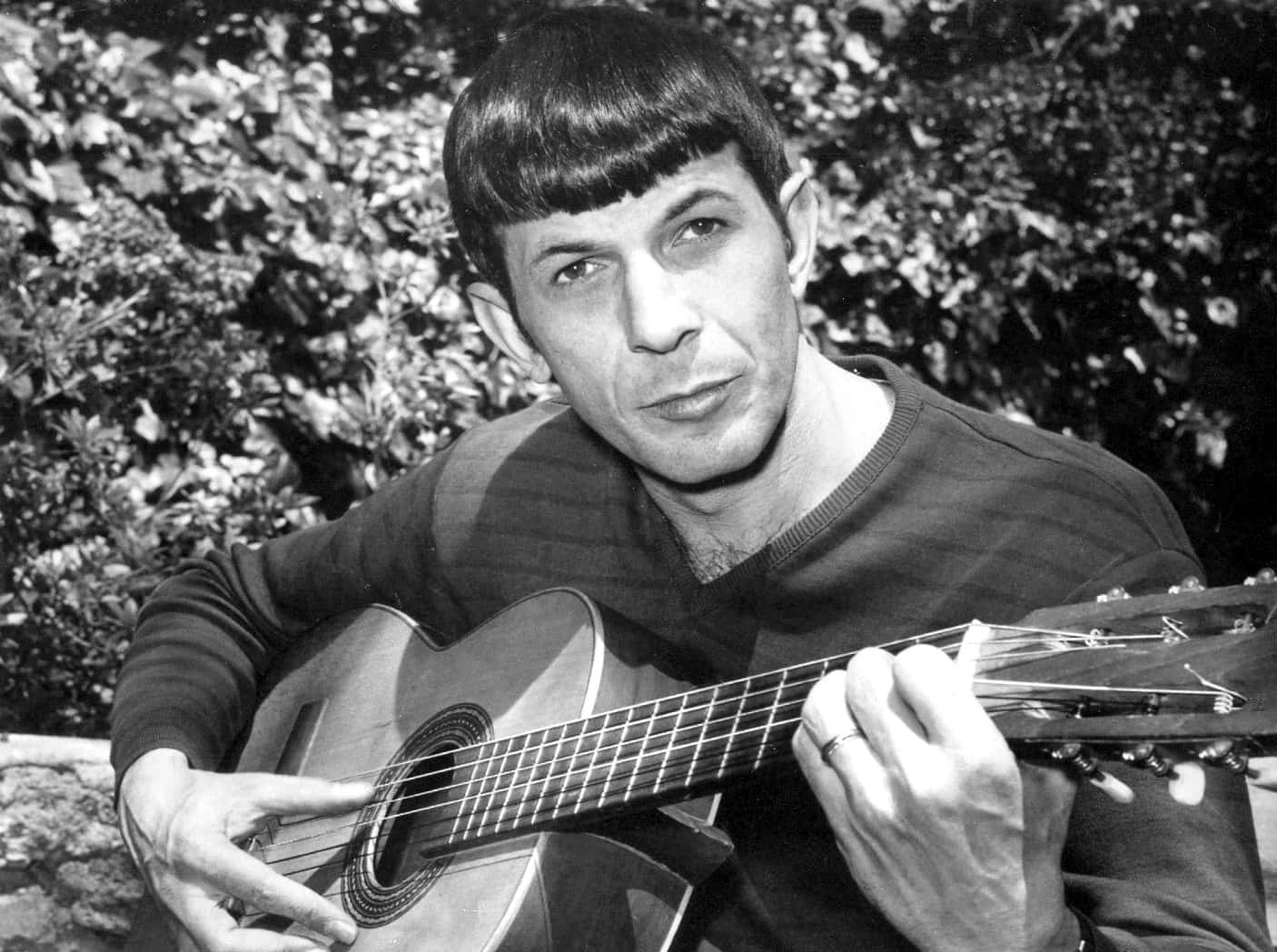 American Actor Leonard Nimoy Playing Guitar In 1967 Background