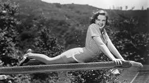 American Actress Judy Garland Posing On Diving Board Background