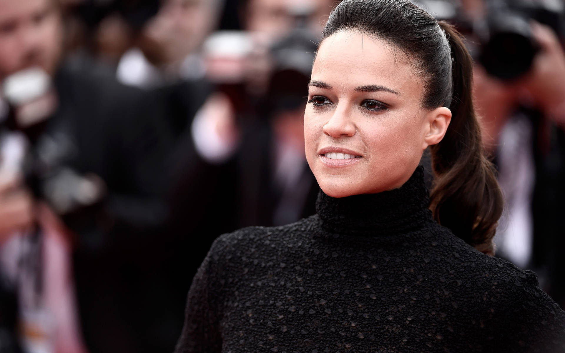 American Actress Michelle Rodriguez On The Red Carpet Background