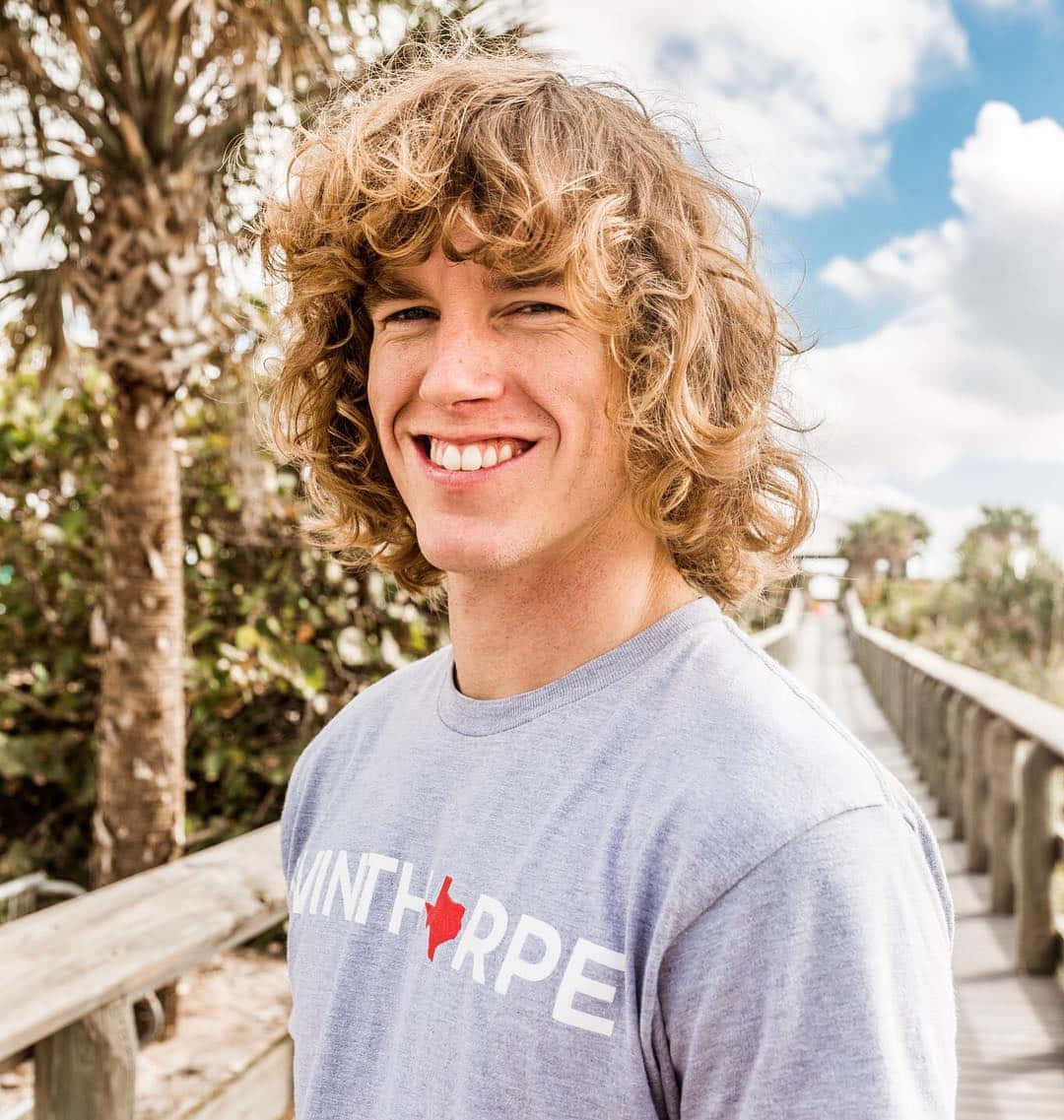 American Celebrity Danny Duncan On A Wooden Pathway Background