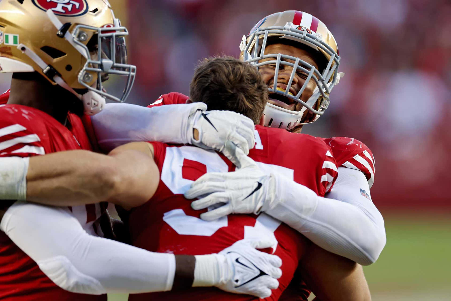 American Defensive Lineman Arik Armstead Hugging Nick Bosa Background