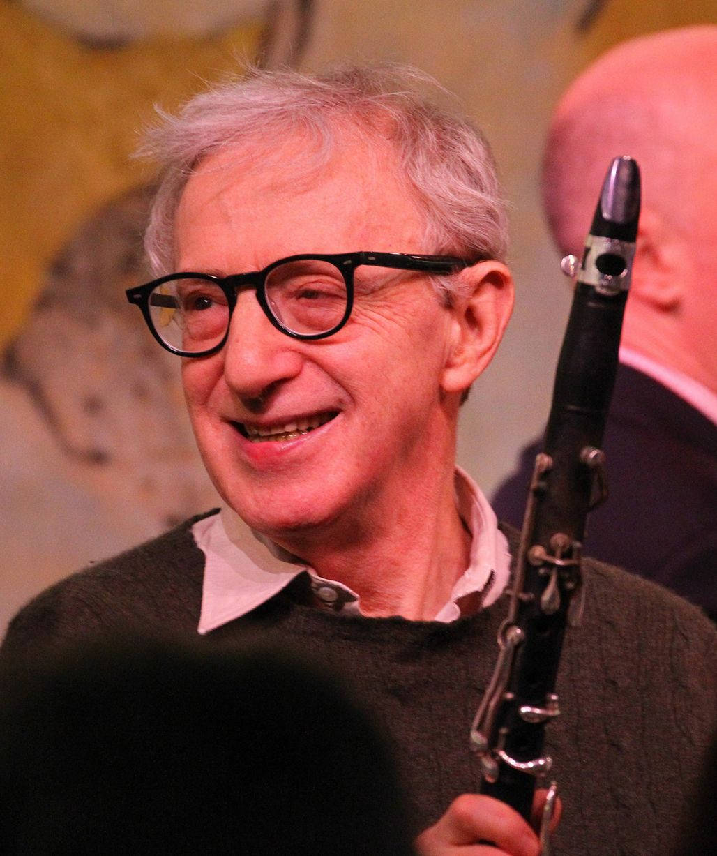 American Filmmaker Woody Allen Holding A Saxophone Background