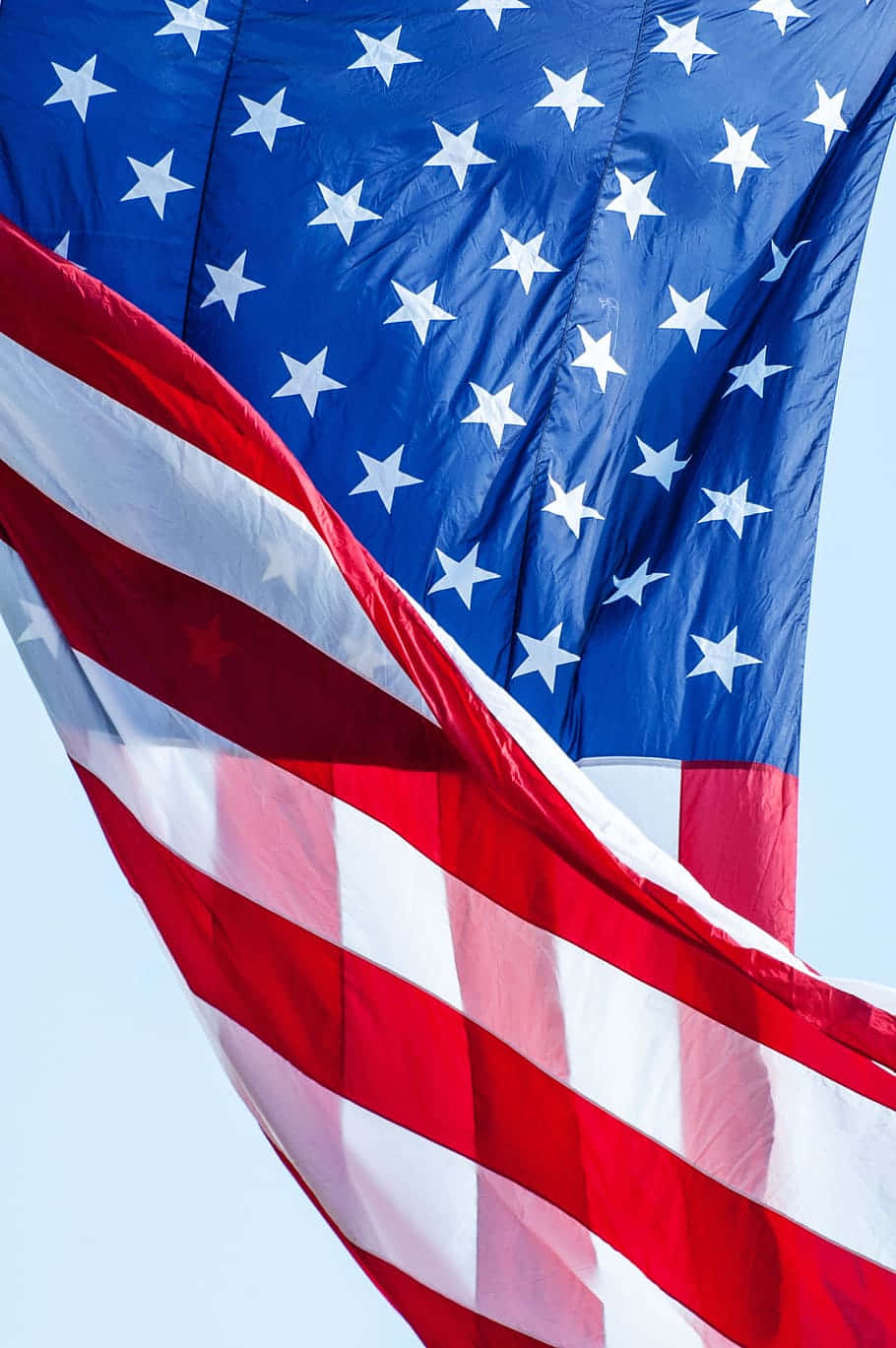 American Flag Waving Against Sky Background