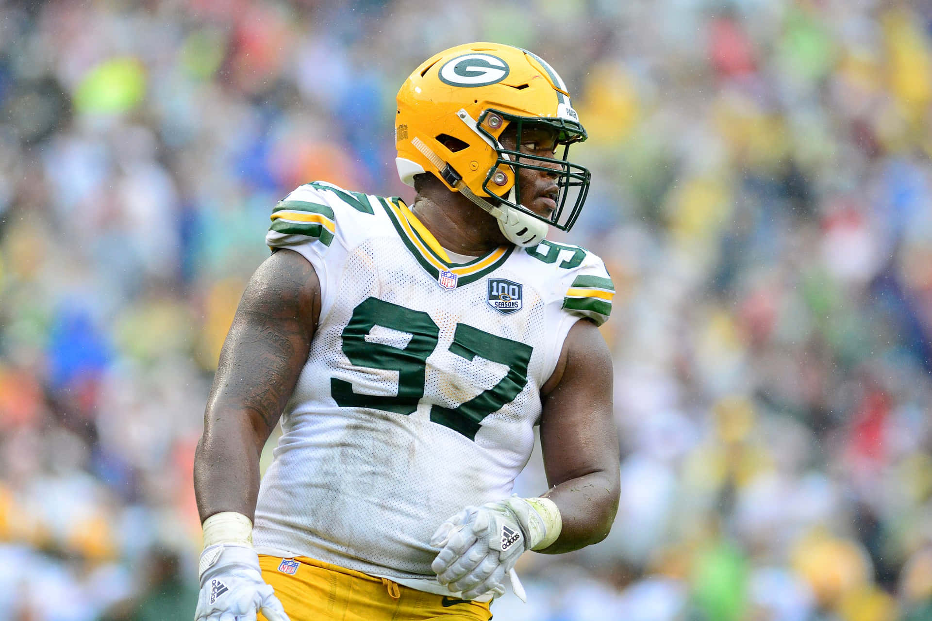 American Football Defensive Tackle Kenny Clark On Field Background