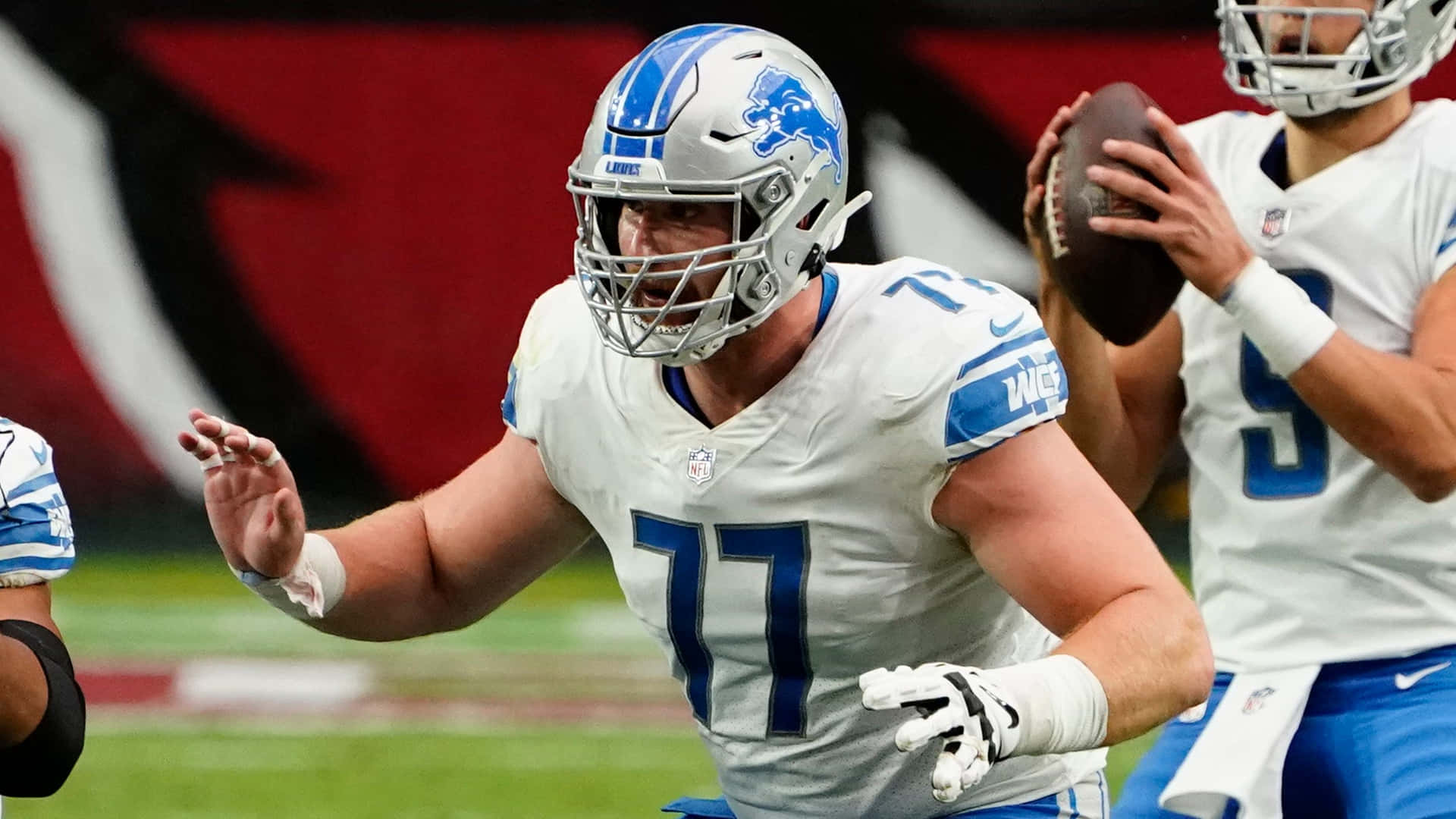 American Footballer Frank Ragnow With Teammates Background