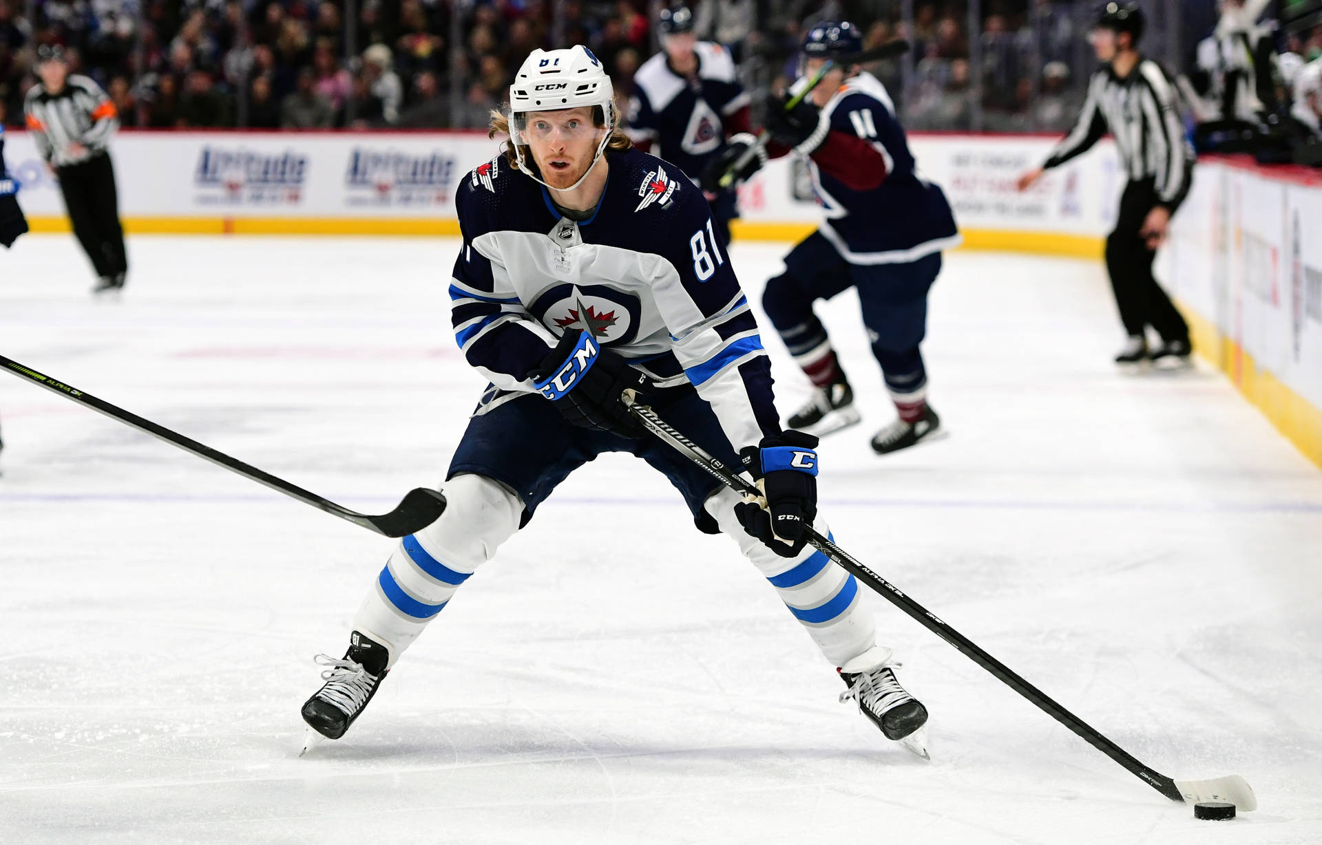 American Ice Hockey Player Kyle Connor Carrying The Puck Background