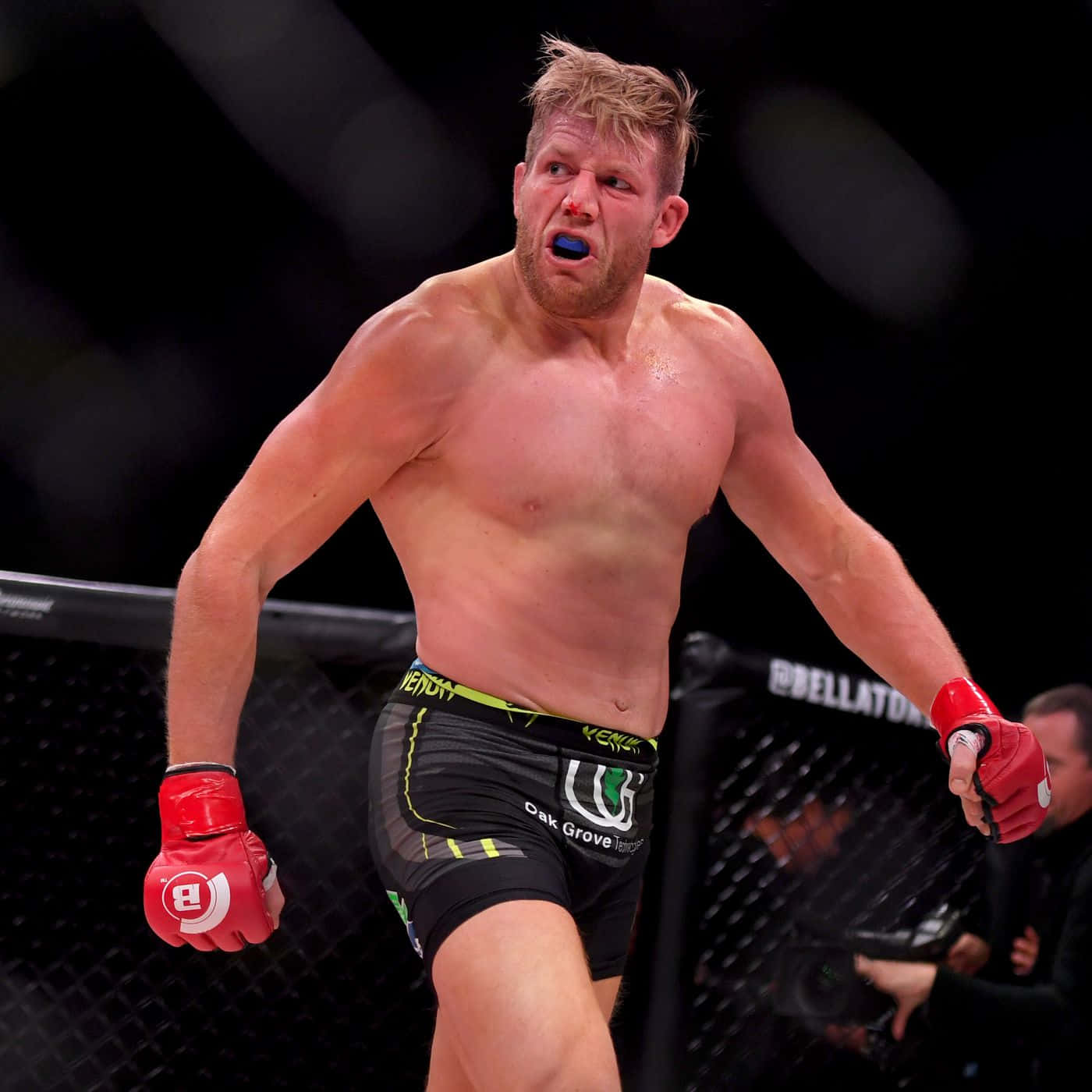 American Mixed Martial Artist Jake Hager In Bellator Cage Background