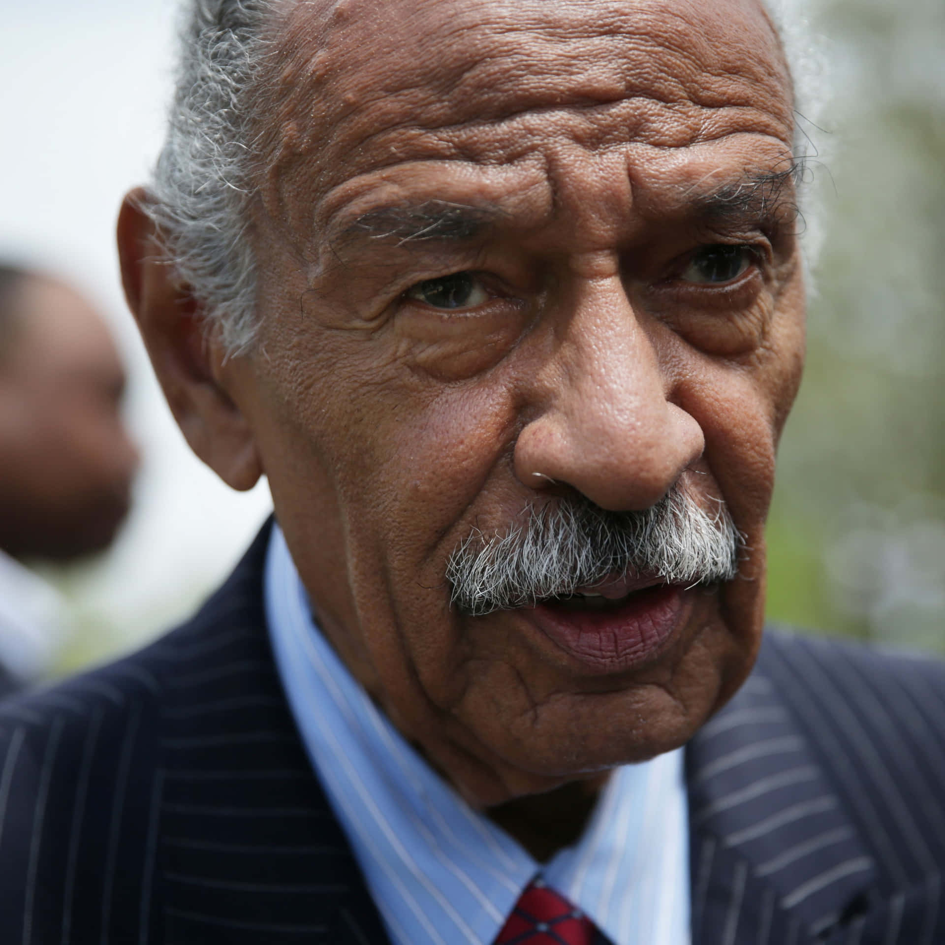 American Politician John Conyers Jr. At A Political Event Background