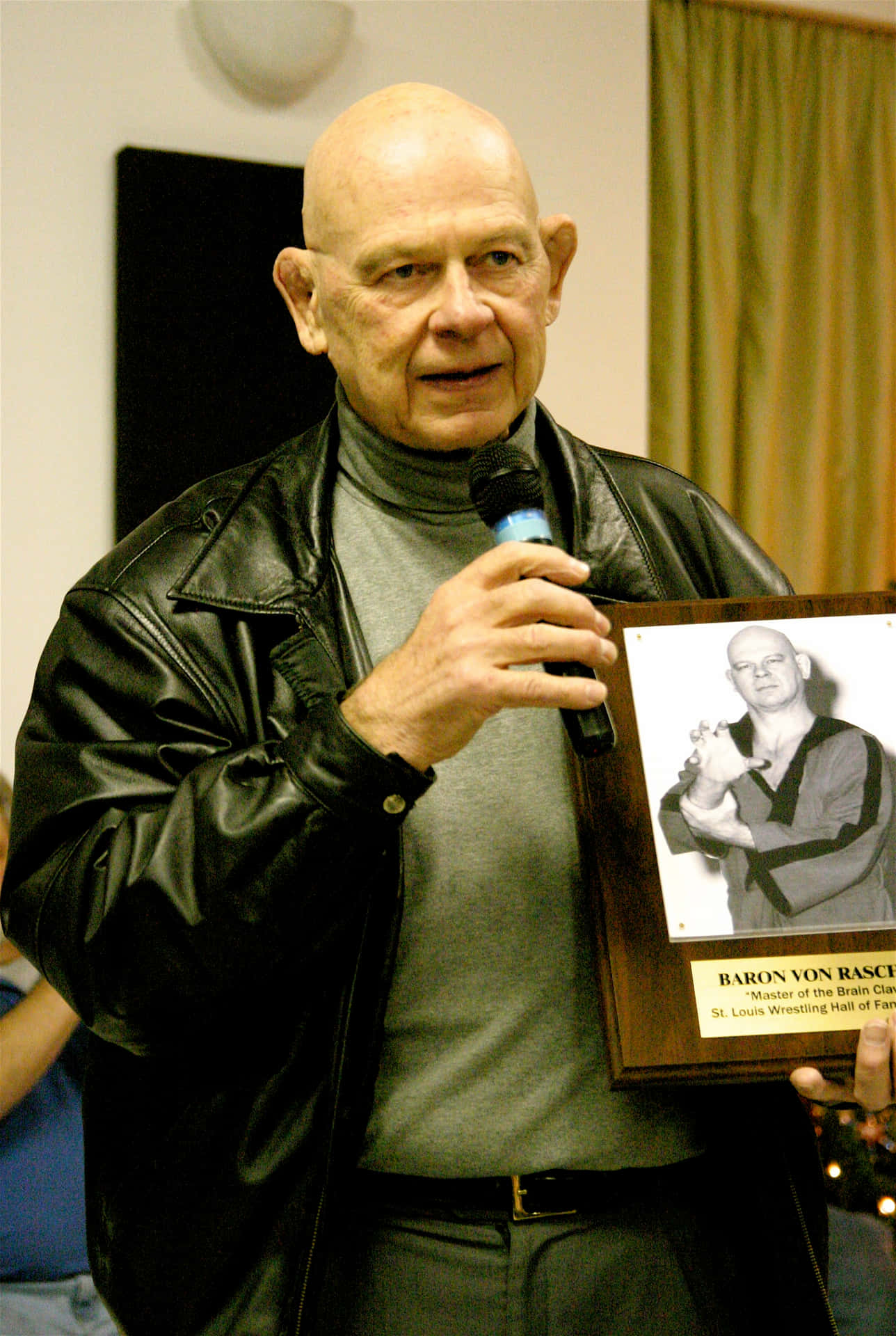 American Retired Wrestler Baron Von Raschke Holding His Memorabilia Portrait Background