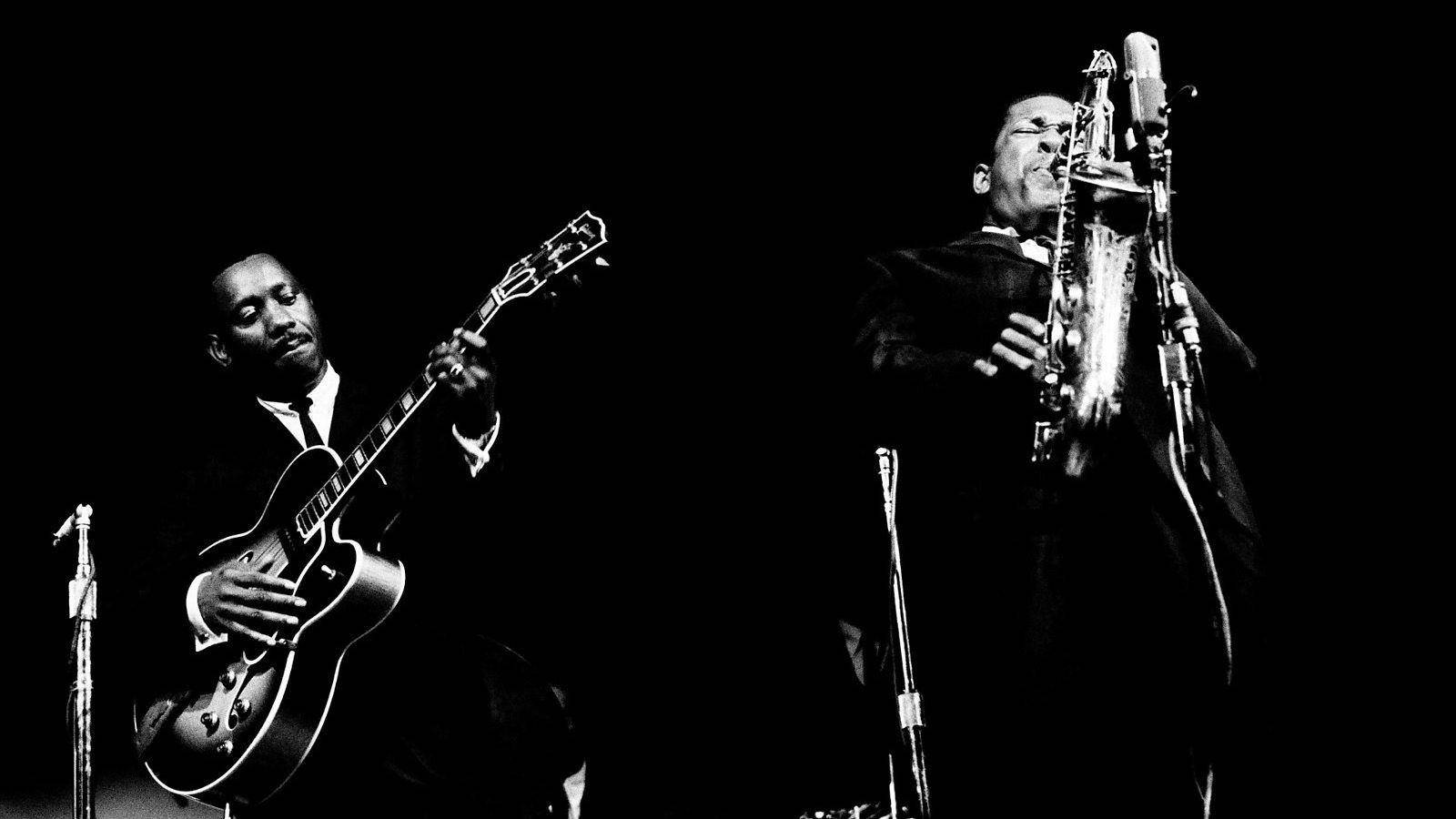 American Saxophonist John Coltrane And Guitarist Wes Montgomery Background